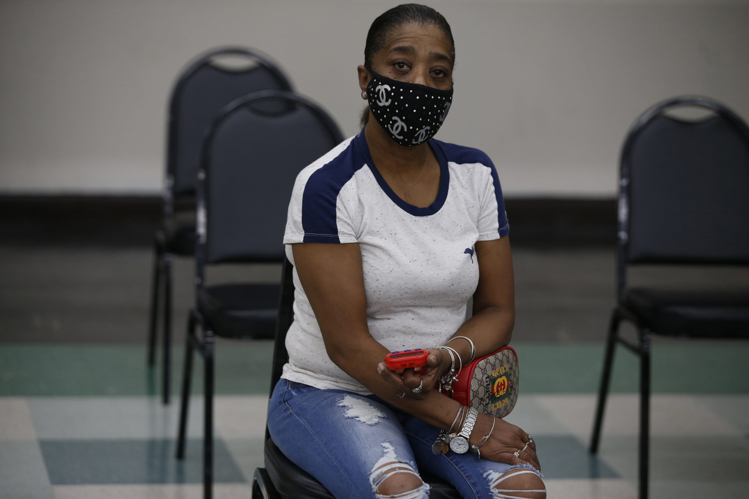Shirley Walker waits with timer, set to 15 minutes after getting her Covid-19 vaccination at the  Prince Hall Grand Lodge in Dorchester, MA.               Jonathan Wiggs/Globe Staff