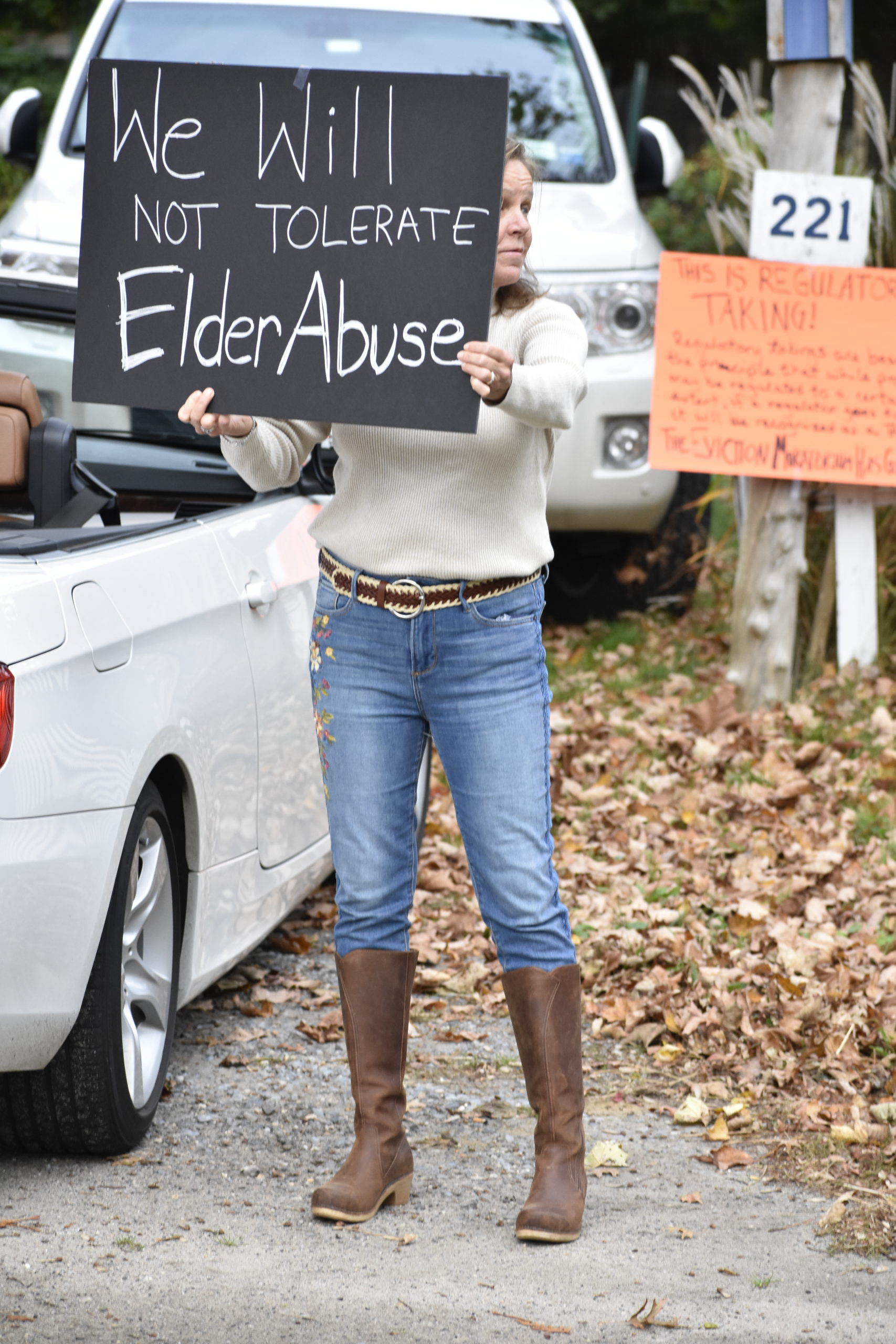 A demonstrator in front of Lynn Matsuoka's house on Monday.