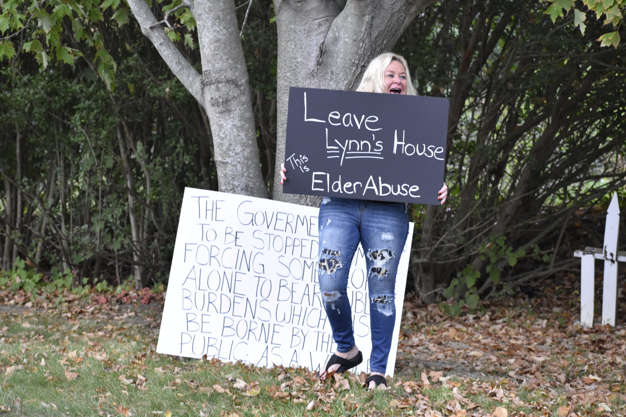 Christine Brennan protests Monday in front of Lynn Matsuoka's house.
