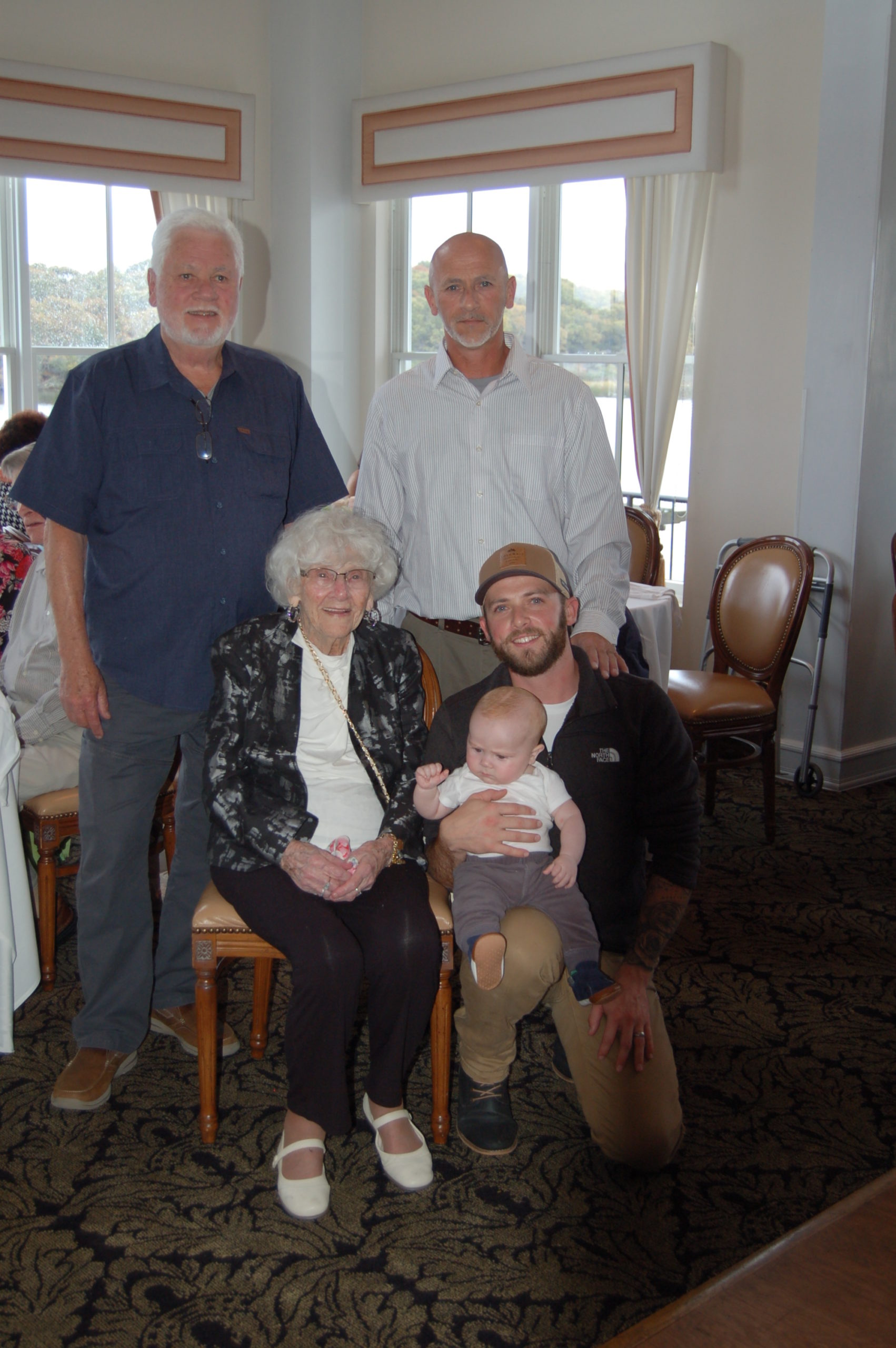 Gladys Raynor, seated, of Eastport recently celebrated her 100th birthday with her family including, left to right,  son Ron Dyke, grandson Jimmy Dyke, great grandson James Dyke, kneeling, and great-great-grandson Hunter Dyke.  COURTESY MACOMBER FAMILY