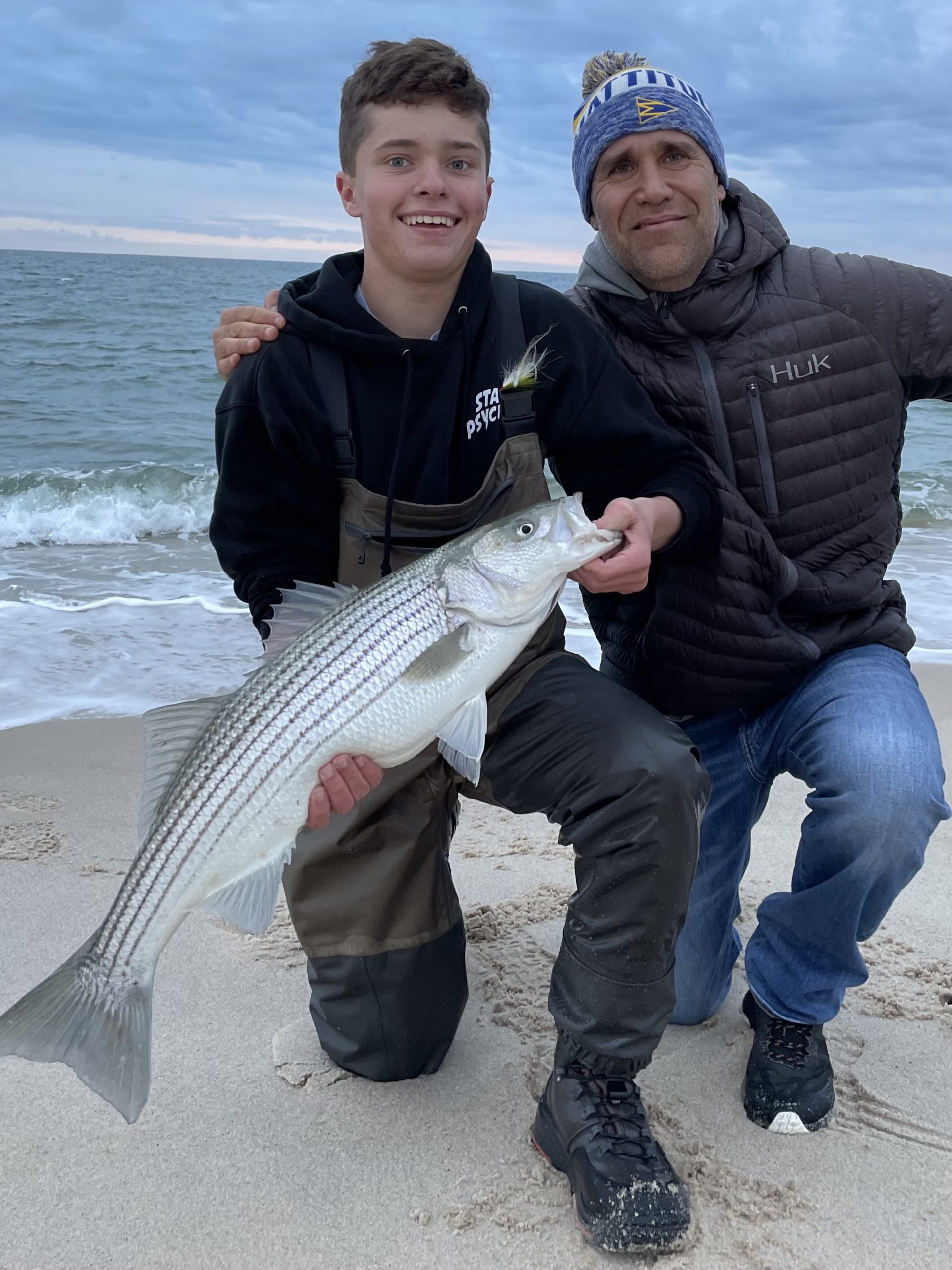 Jackson and Eric Frend with a nice striper caught on a Southampton beach on Sunday.