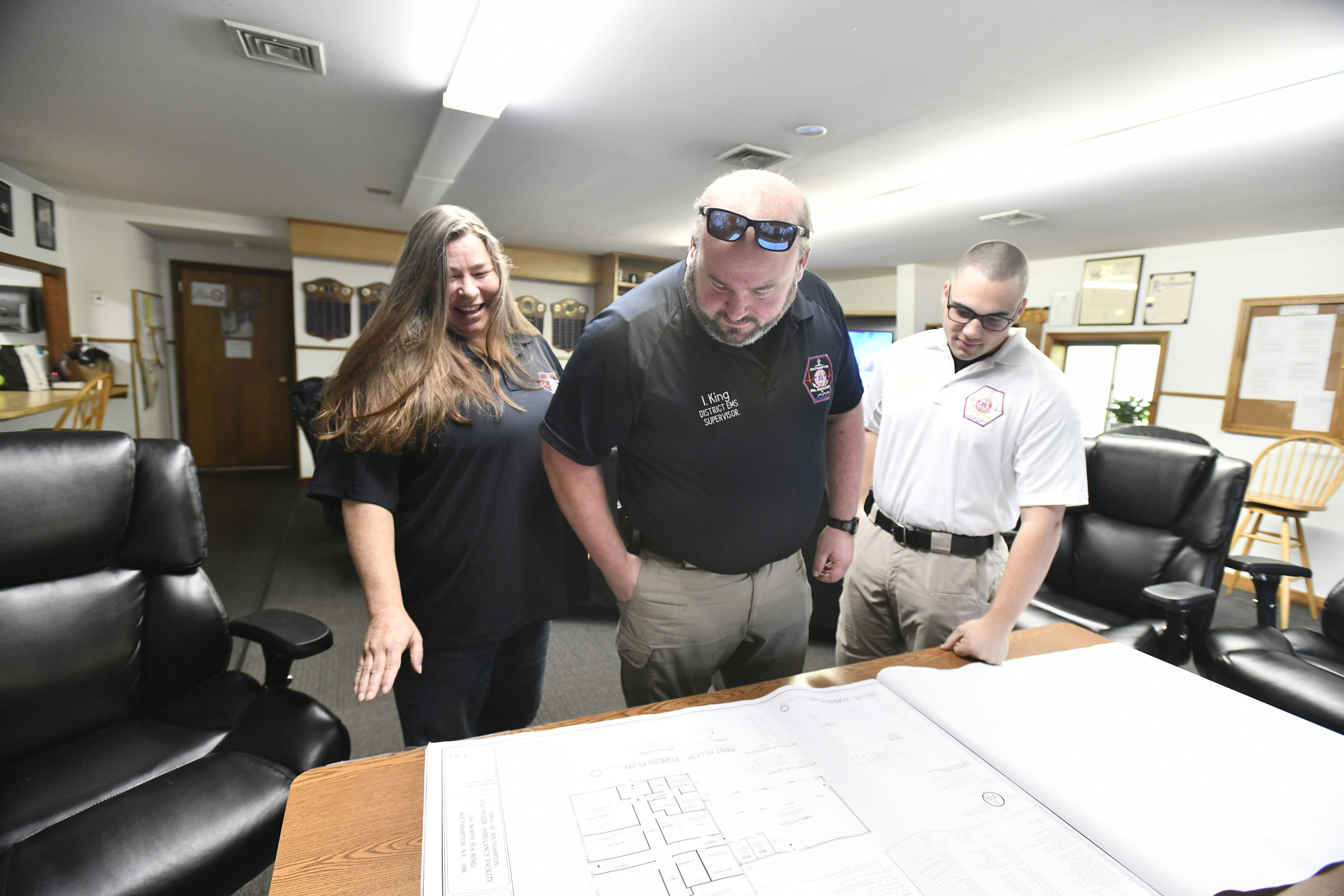 Donna Kreymborg, Ian King and Joseph M. Riccardi look over plans for the new ambulance barn.     DANA SHAW