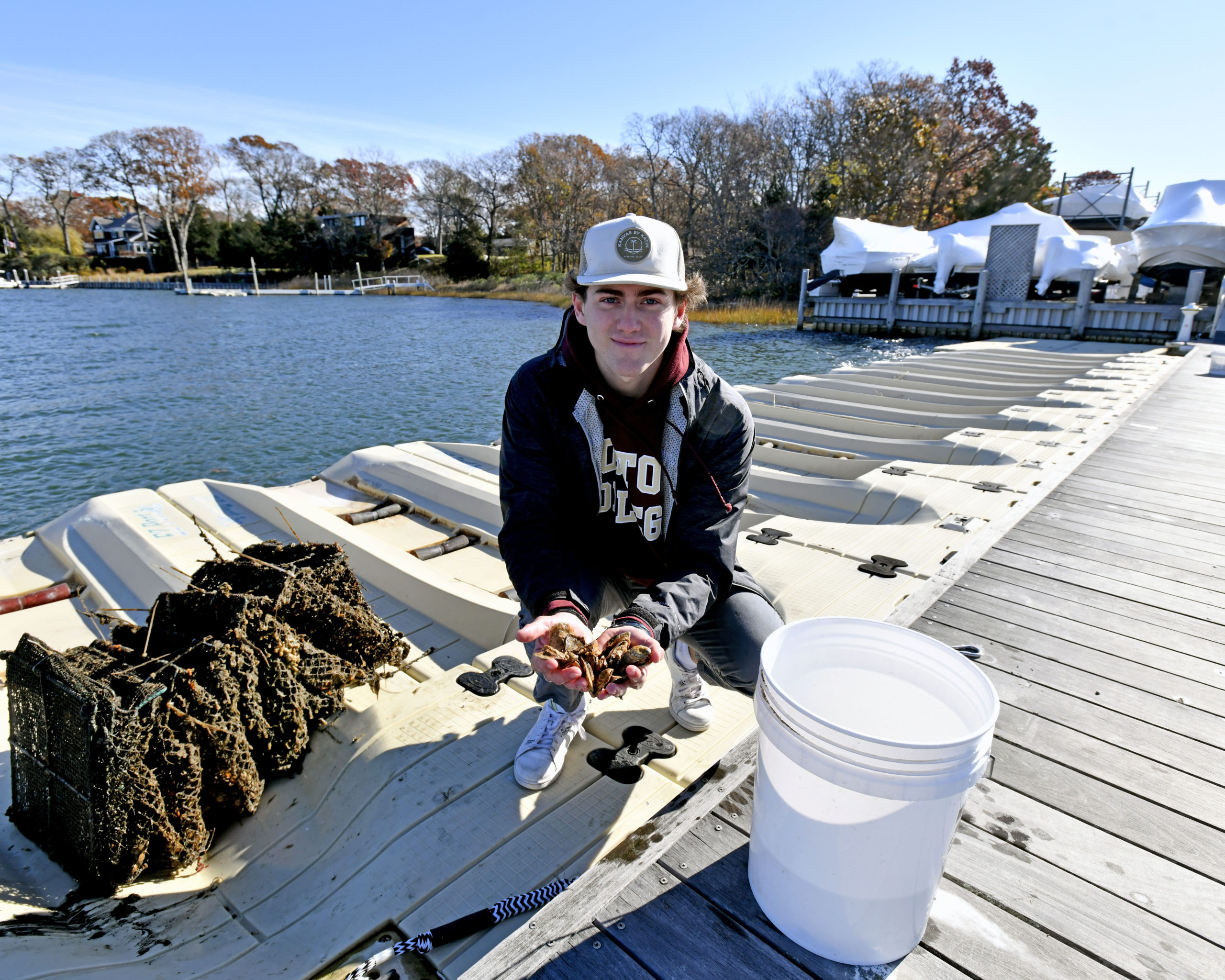 Pierson Senior Reed Kelsey at Mill Creek Marina in Noyac where he is working on a shellfish restoration project with oysters and scallops.  DANA SHAW