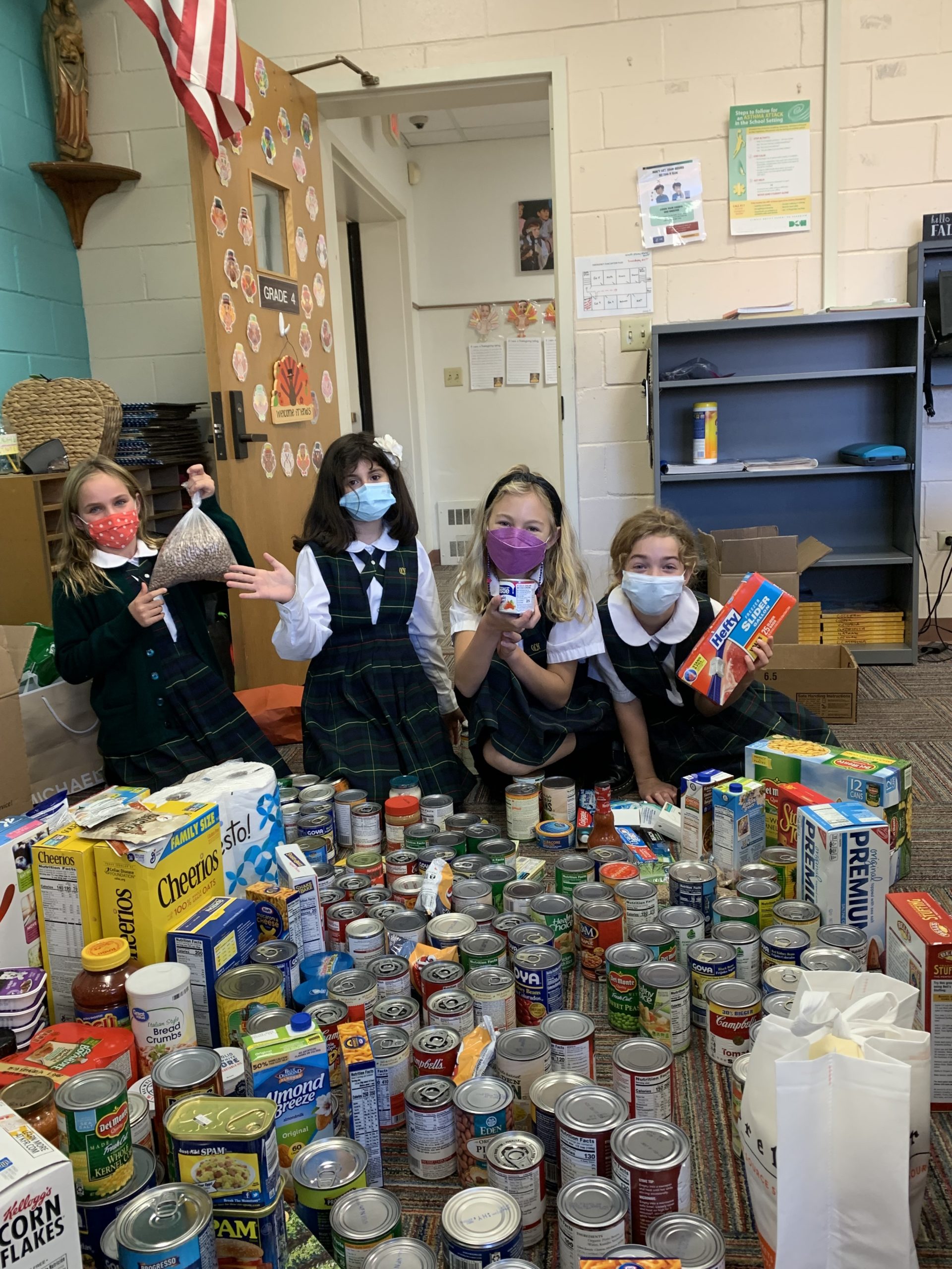 Our Lady of the Hamptons School fourth graders packed more than 1,000 Thanksgiving food drive items to be donated to the food pantry.