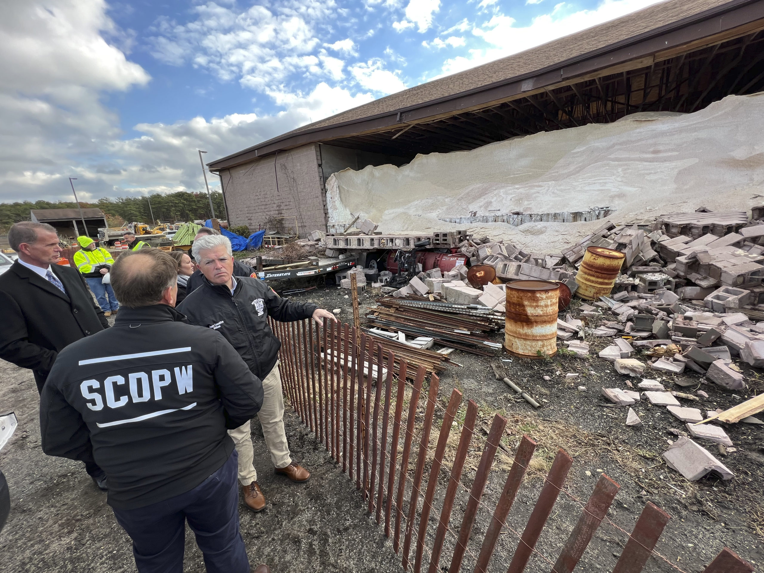 Suffolk County Executive Steve Bellone surveys the damage at the Suffolk County DPW yard and salt barn in Westhampton which sustained significant damage from a confirmed tornado on Saturday leaving it structurally unsound.      DANA SHAW