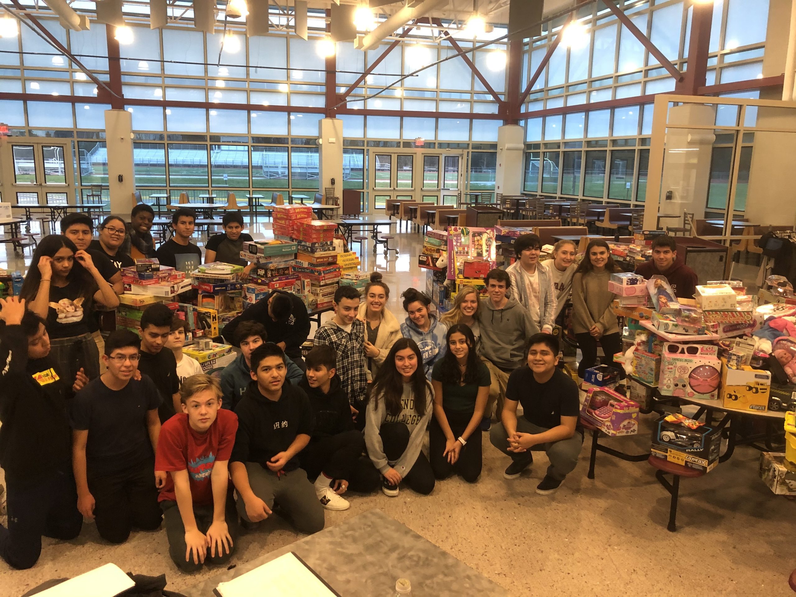 Members of the East Hampton High School Key Club gather with collected toys before beginning the sorting process as part of the East Hampton Kiwanis Club's annual toy drive for the holidays. COURTESY DR. LOUIS PROFERA