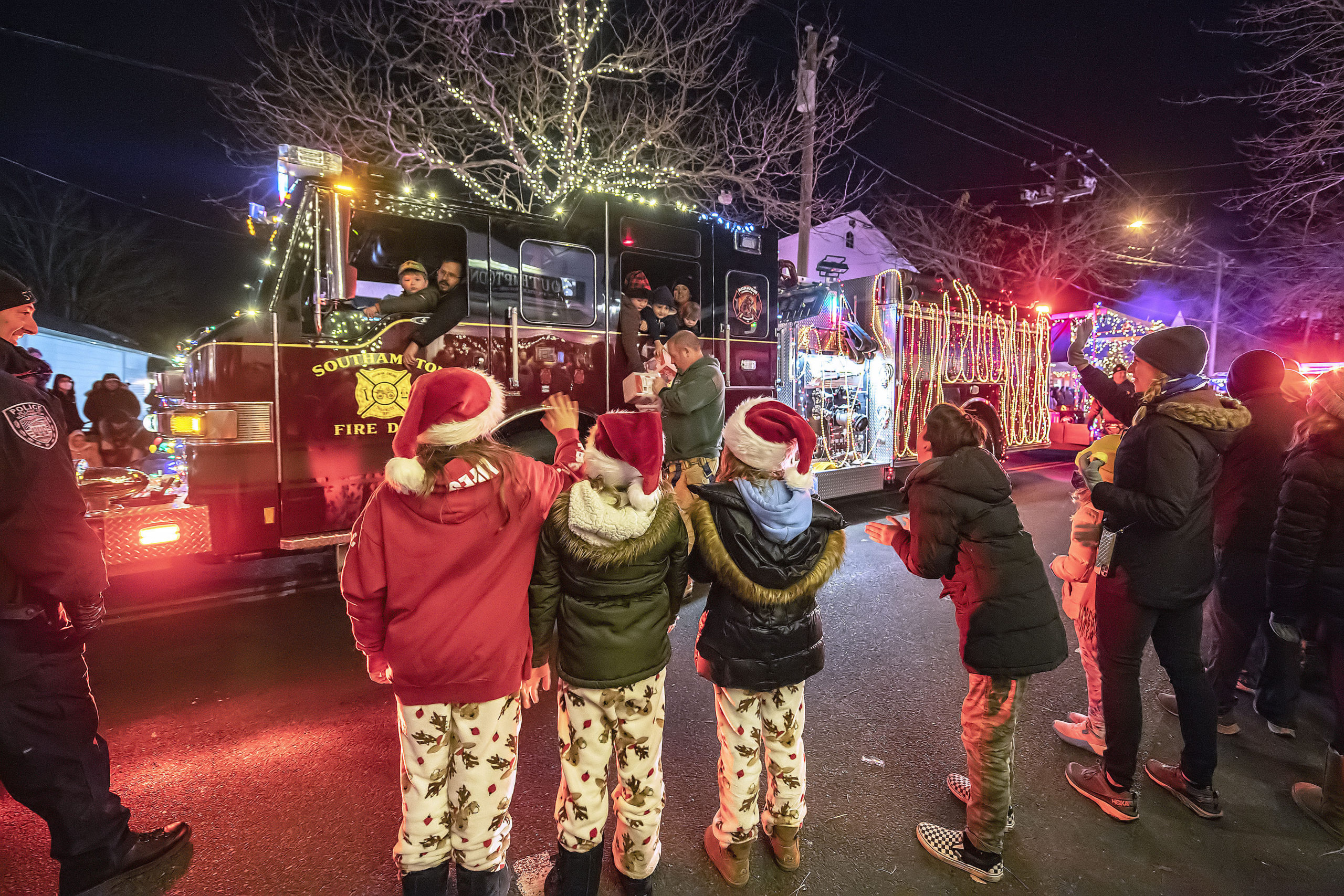 A Southampton Fire Department pumper truck delights the crowd during the 2021 Parade of Lights along Jobs Lane on Saturday night.   MICHAEL HELLER