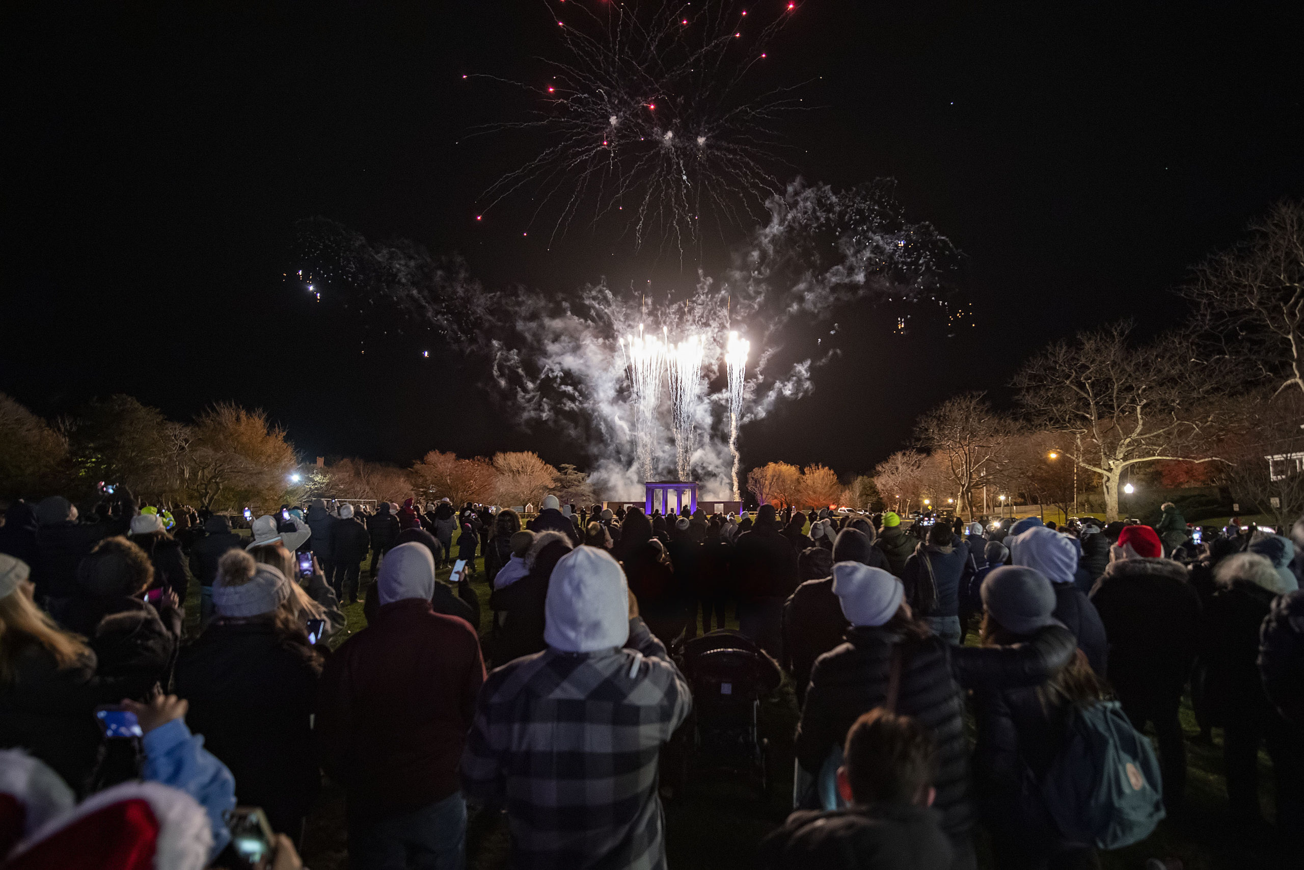 The crowd watches fireworks launched from behind the monument in Agawam Park on Saturday night.  MICHAEL HELLER