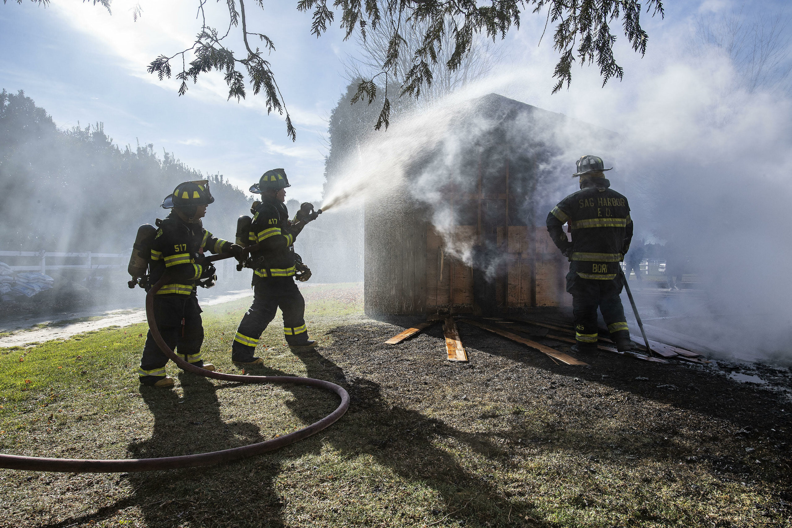 Firefighters douse a burning building at Apple Wild Farm in Bridgehampton on Wednesday, December 1. 