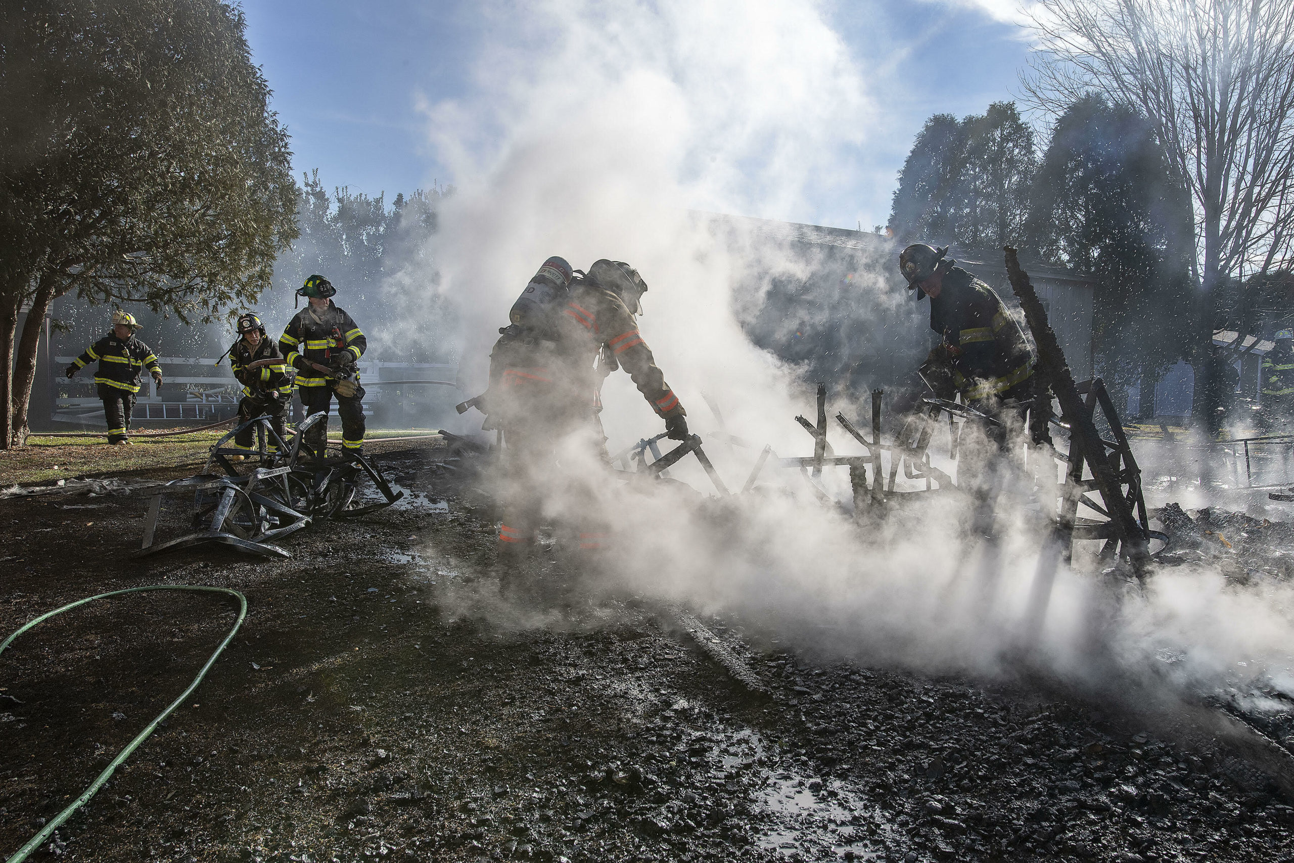 Firefighters douse a fire that destroyed an outbuilding at Apple Wild Farm in Bridgehampton on Wednesday, December 1. 