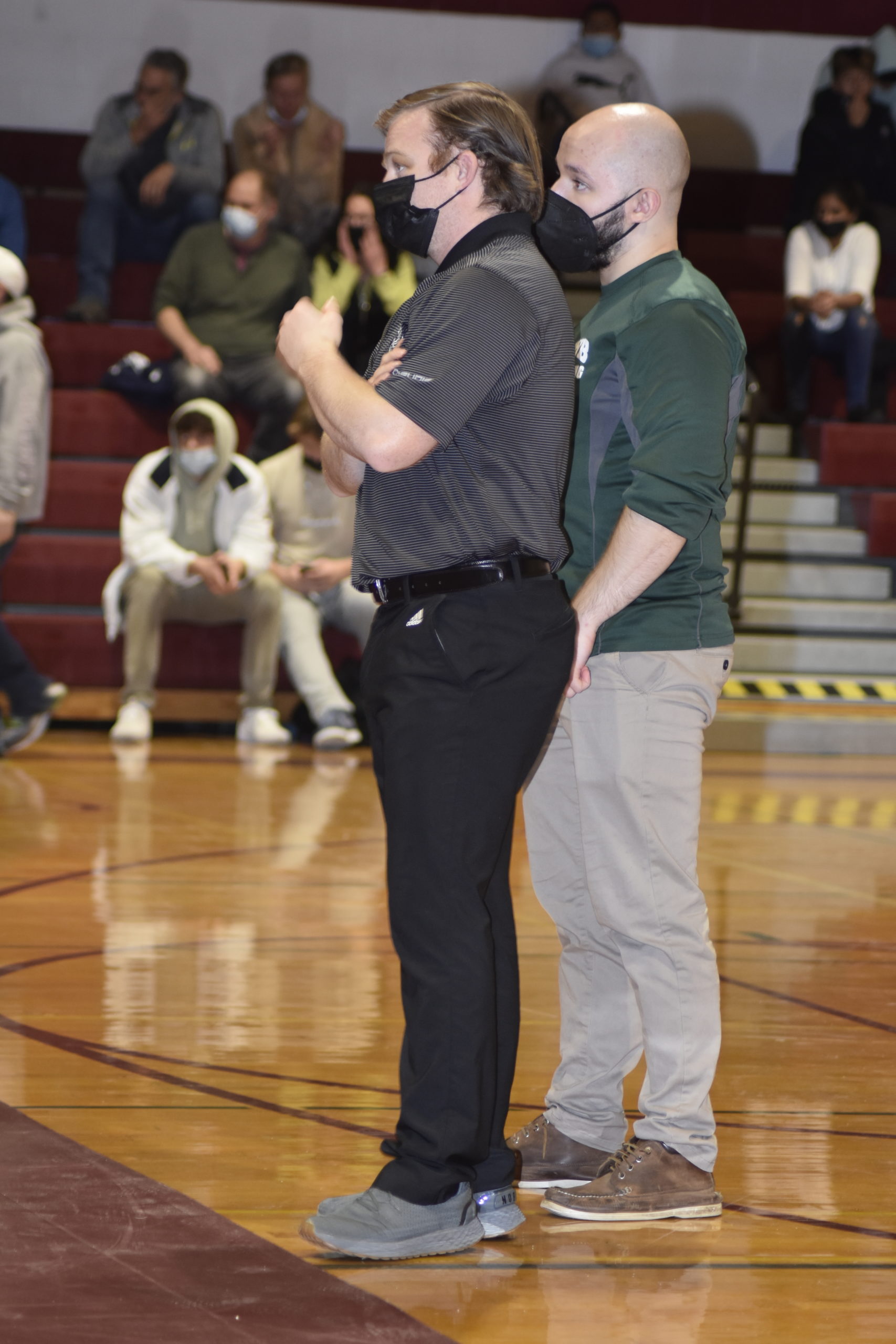 Westhampton Beach head coach Pete Detore, left, and assistant Andrew Petroulias look on.