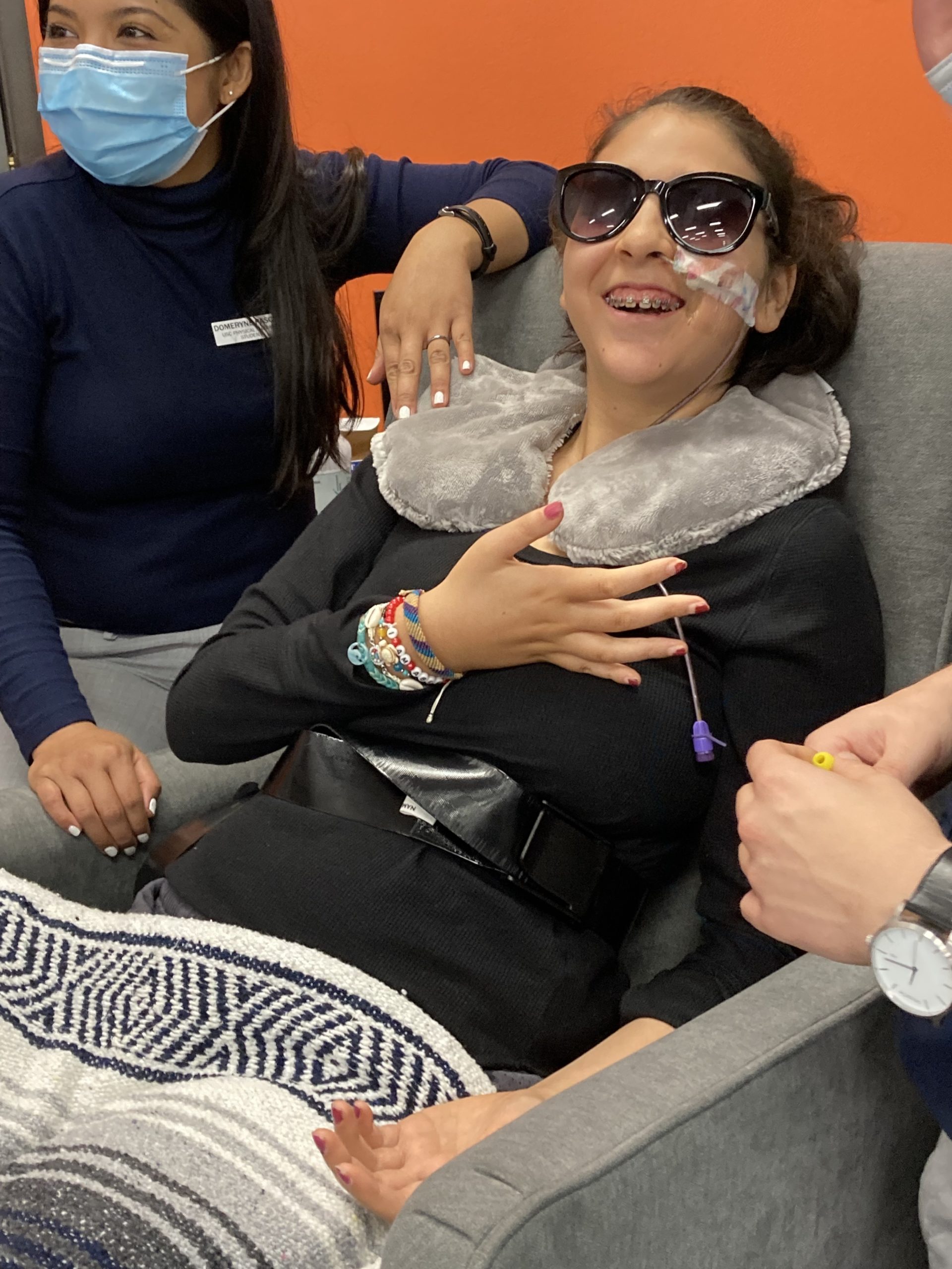 Bella Adlah works on opening all of her fingers at Re+active Physical Therapy in California.