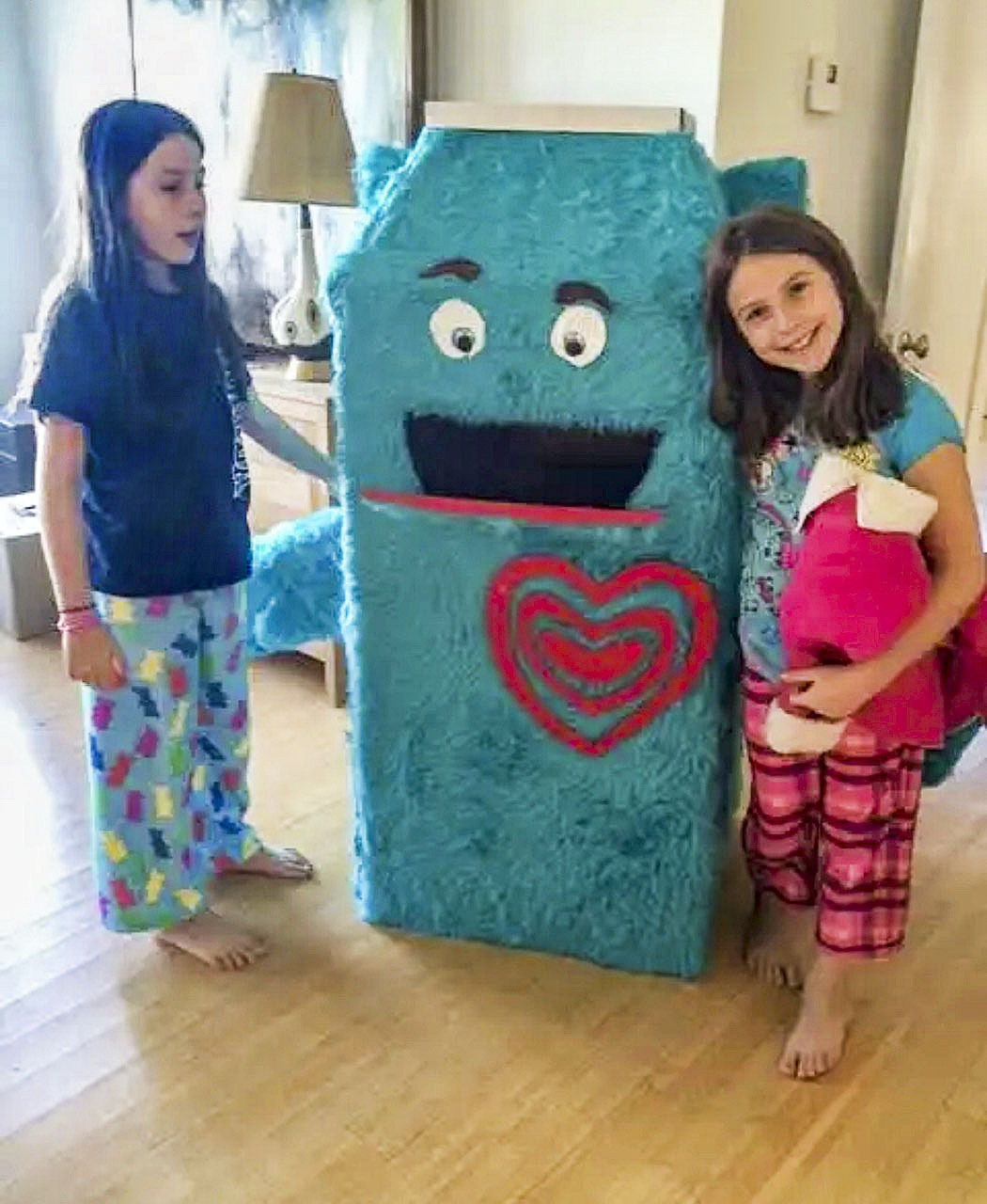 Sisters Marina and Nola Hollyer in the first year they started a coat drive at Sag Harbor Elementary School seven years ago with their homemade donation box, dubbed 