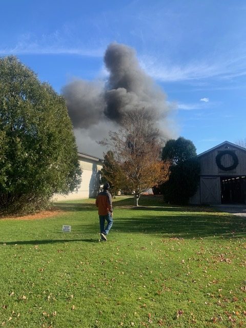 Thick black smoke rose over barns at Apple Wild Farm in Bridgehampton on Wednesday when fire engulfed an outbuilding.