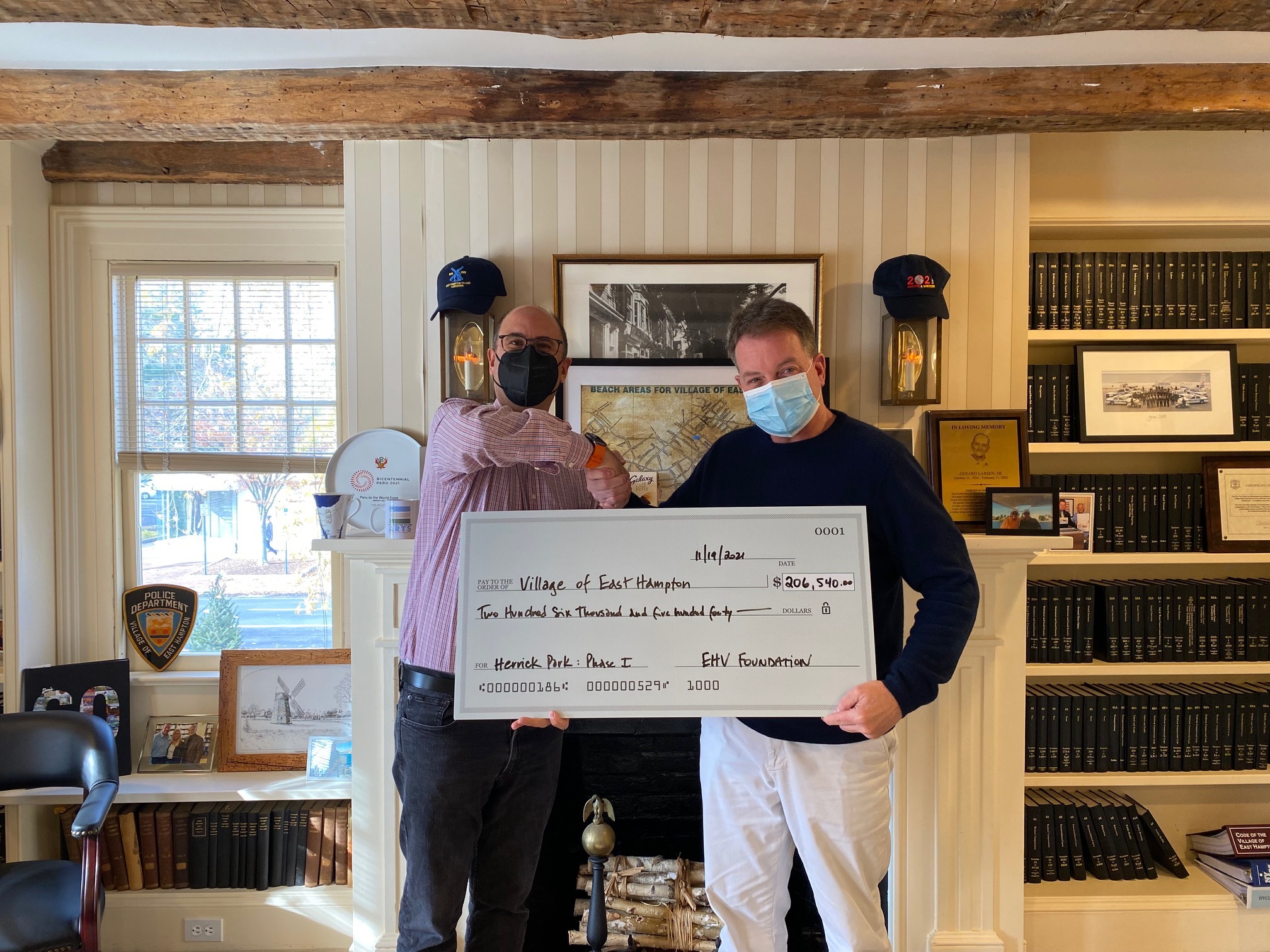 Mayor Jerry Larsen, right, accepts a check for more than $200,000 from East Hampton Village Foundation, presented by foundation chairman Brad Billet, for the Herrick Park renovation designs.