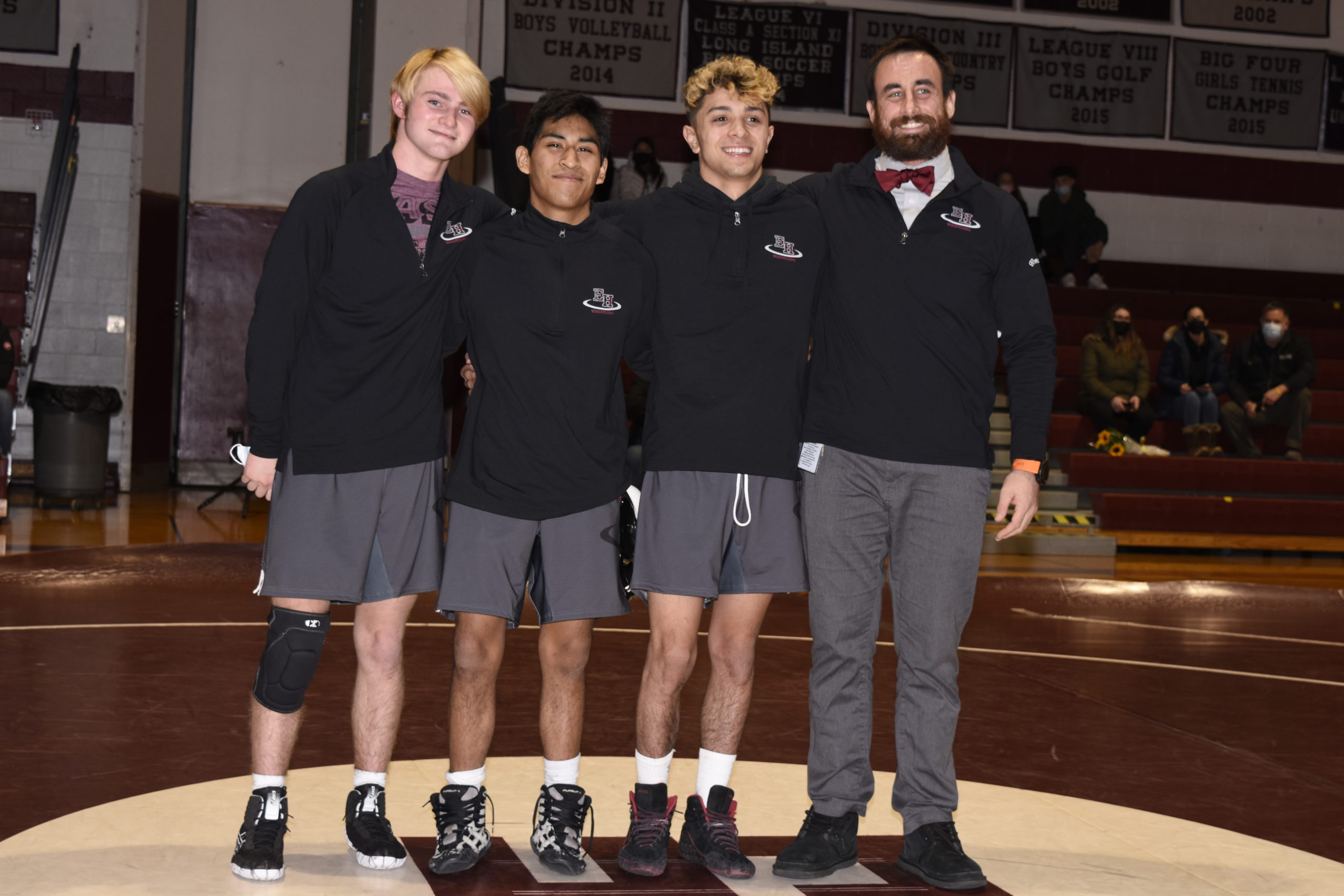 East Hampton seniors, from left, Colin Schaefer, Caleb Peralta and Santi Maya, along with head coach Ethan Mitchell, were honored after their non-league win over Babylon on Thursday, January 27.