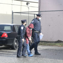 Dominick Parisi is led from his arraignment at Southampton Town Justice Court on Monday morning by Southampton Town Police.  DANA SHAW