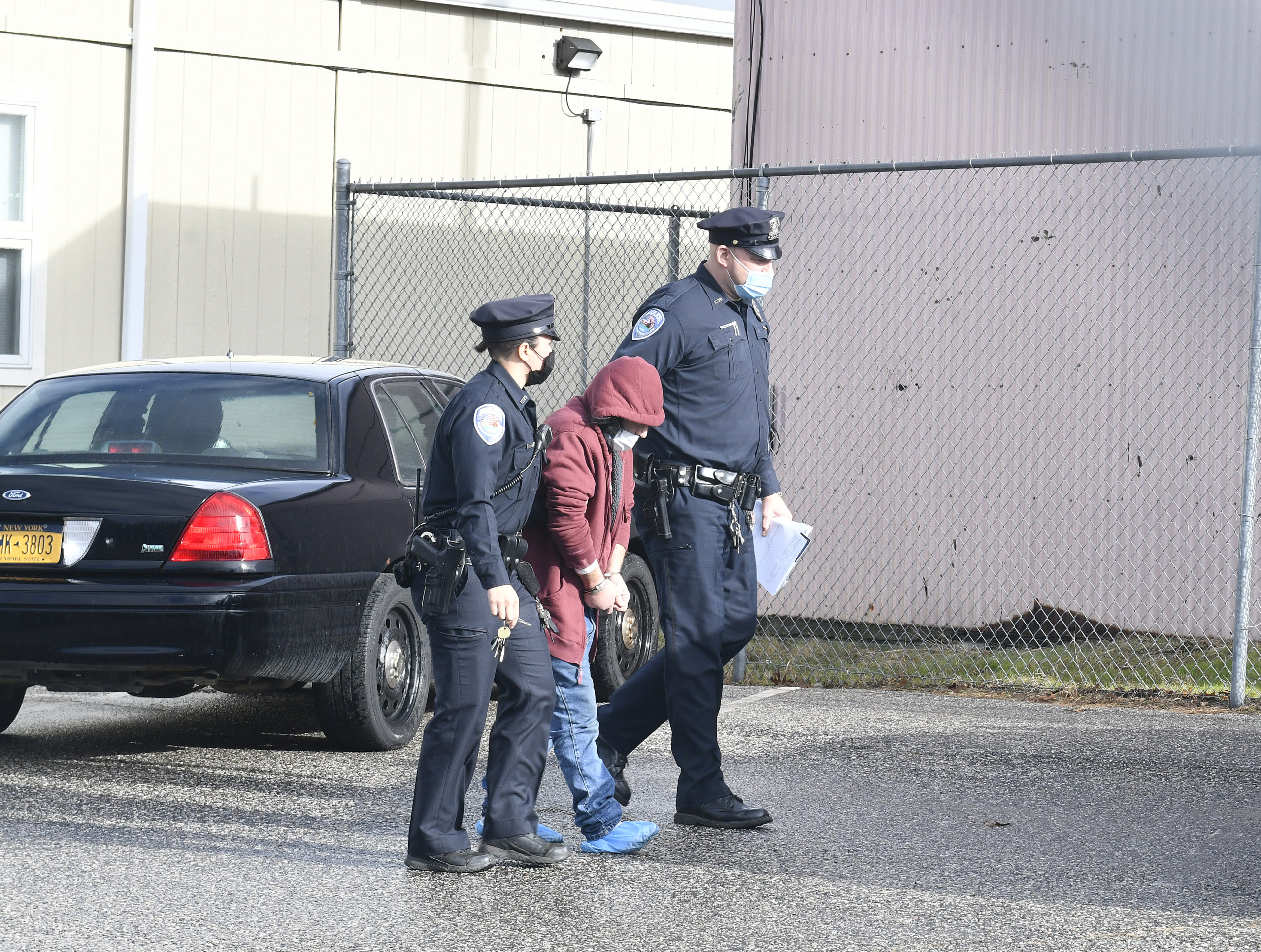Dominick Parisi is led from his arraignment at Southampton Town Justice Court on Monday morning by Southampton Town Police.  DANA SHAW