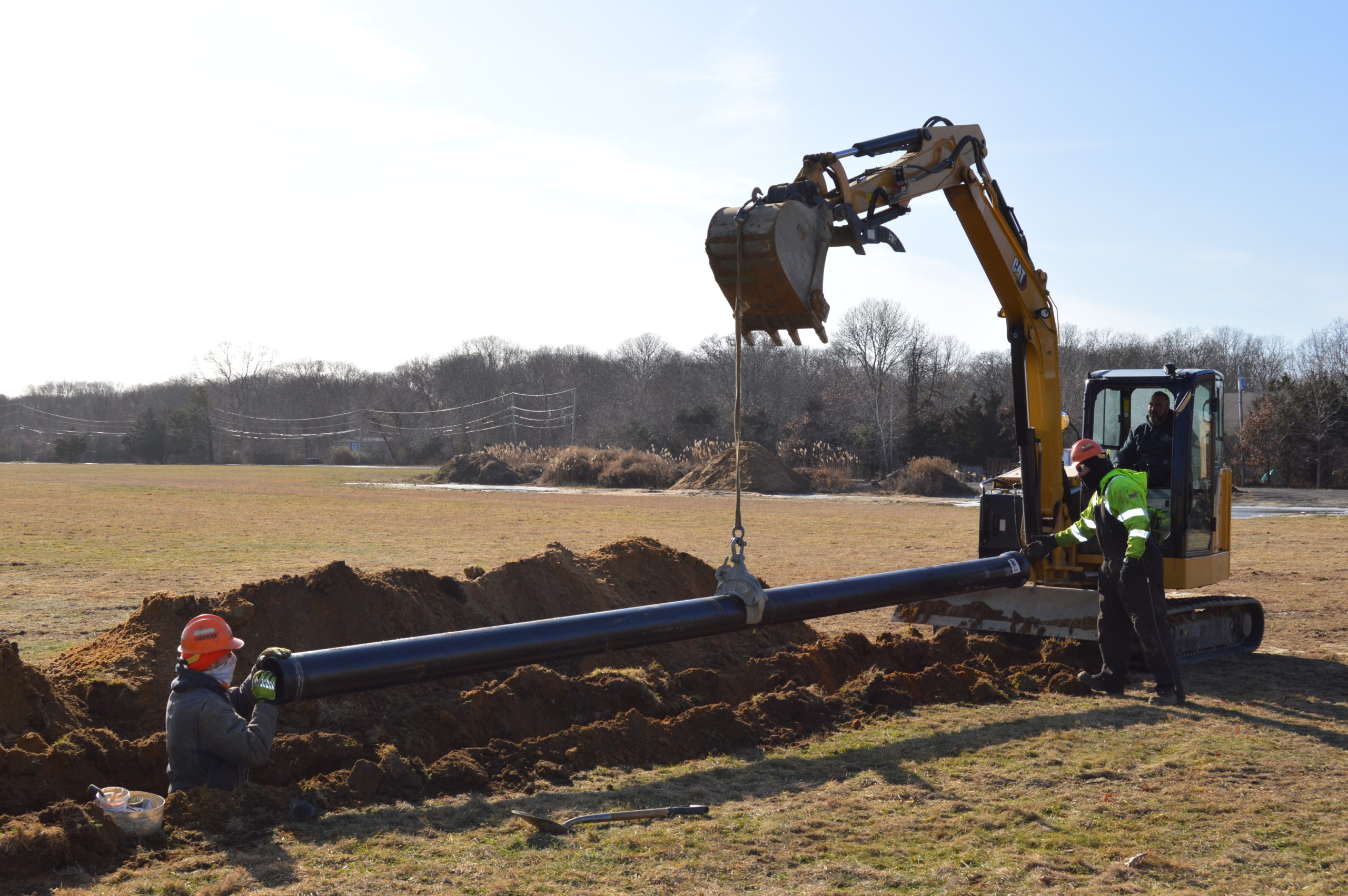 A crew installs a section of new water main at the Shinnecock territory.