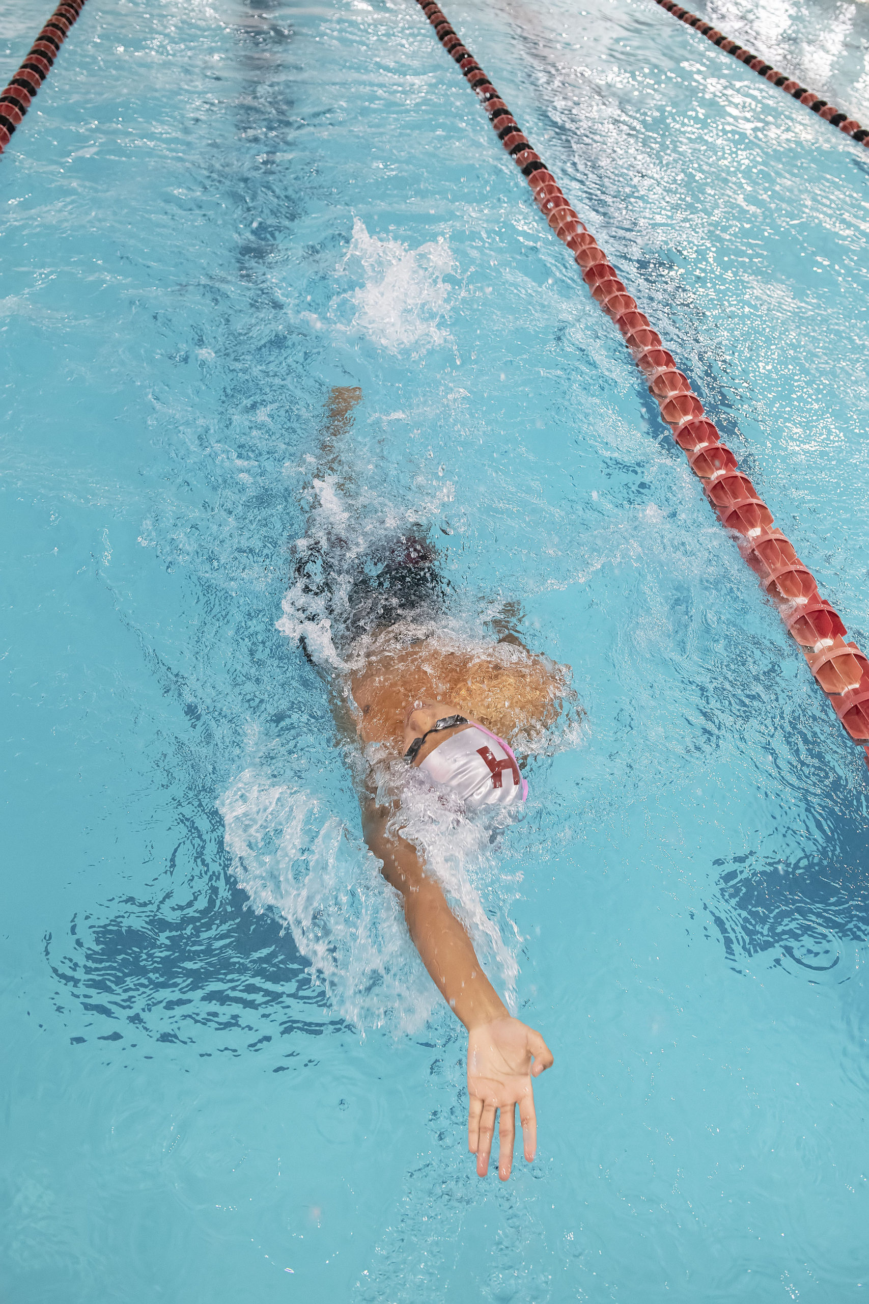 East Hampton's Tenzin Tamang swims the backstroke portion of the 200-yard individual medley.