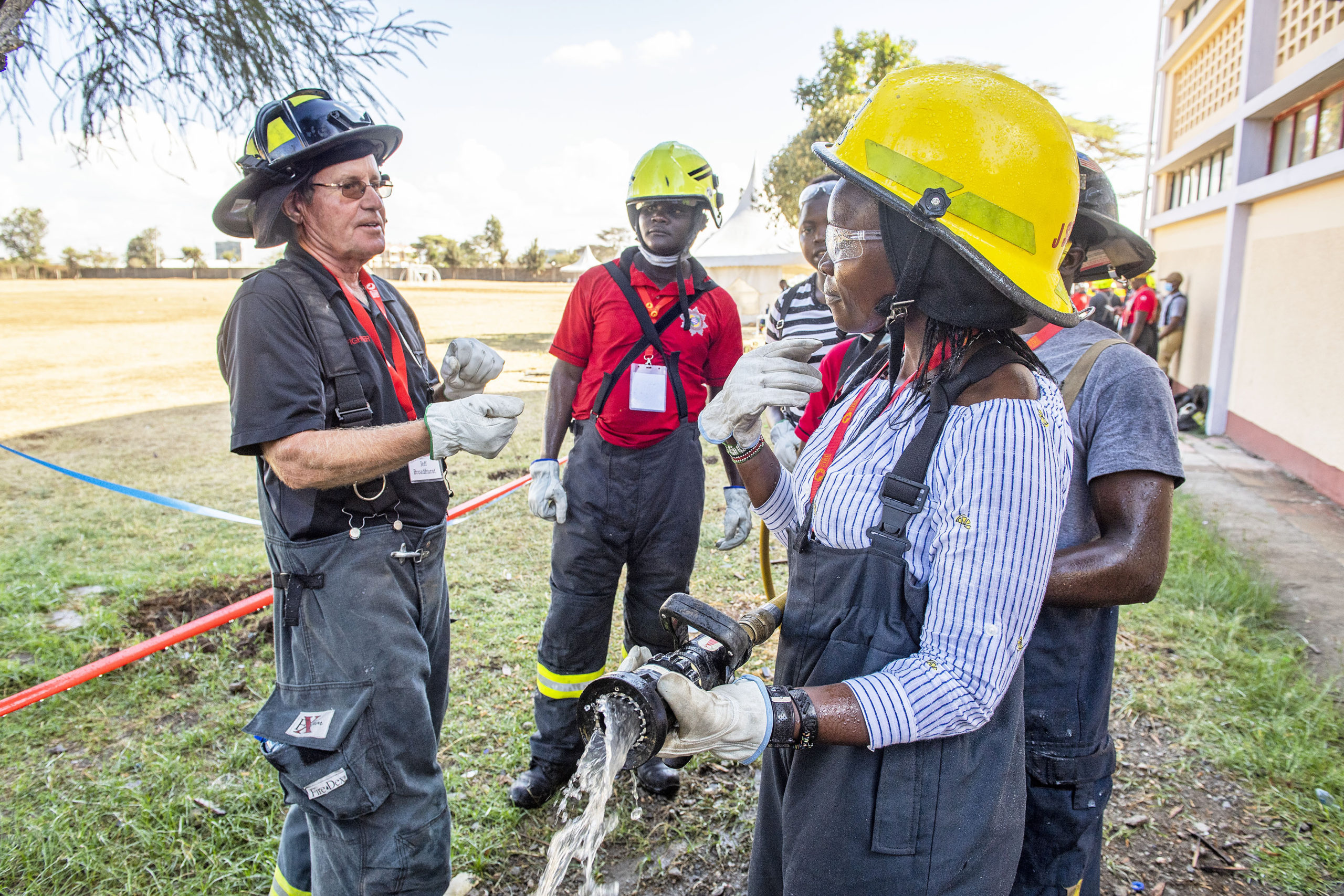 Firefighter Jeff Broadhurst offers advice on hose-handling techniques to Kenyan firefighters during the Africa Fire Mission trip to Nairobi, Kenya in November.