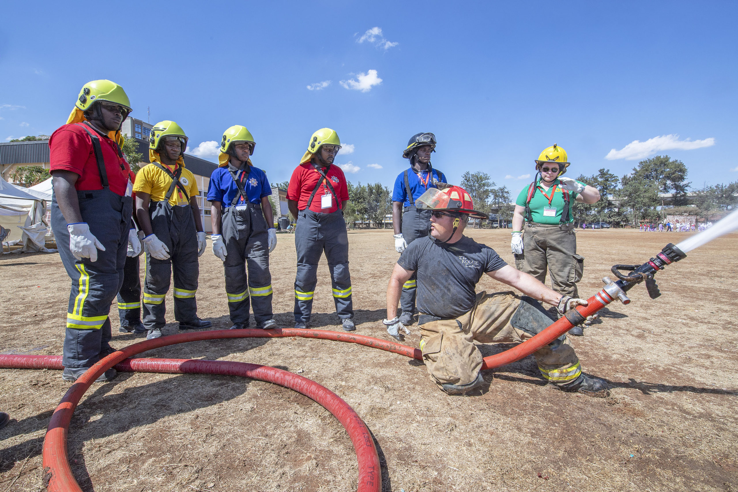 Texas firefighter John Moore gives advice on hose-handling techniques to Kenyan firefighters during the Africa Fire Mission trip to Nairobi, Kenya in November.