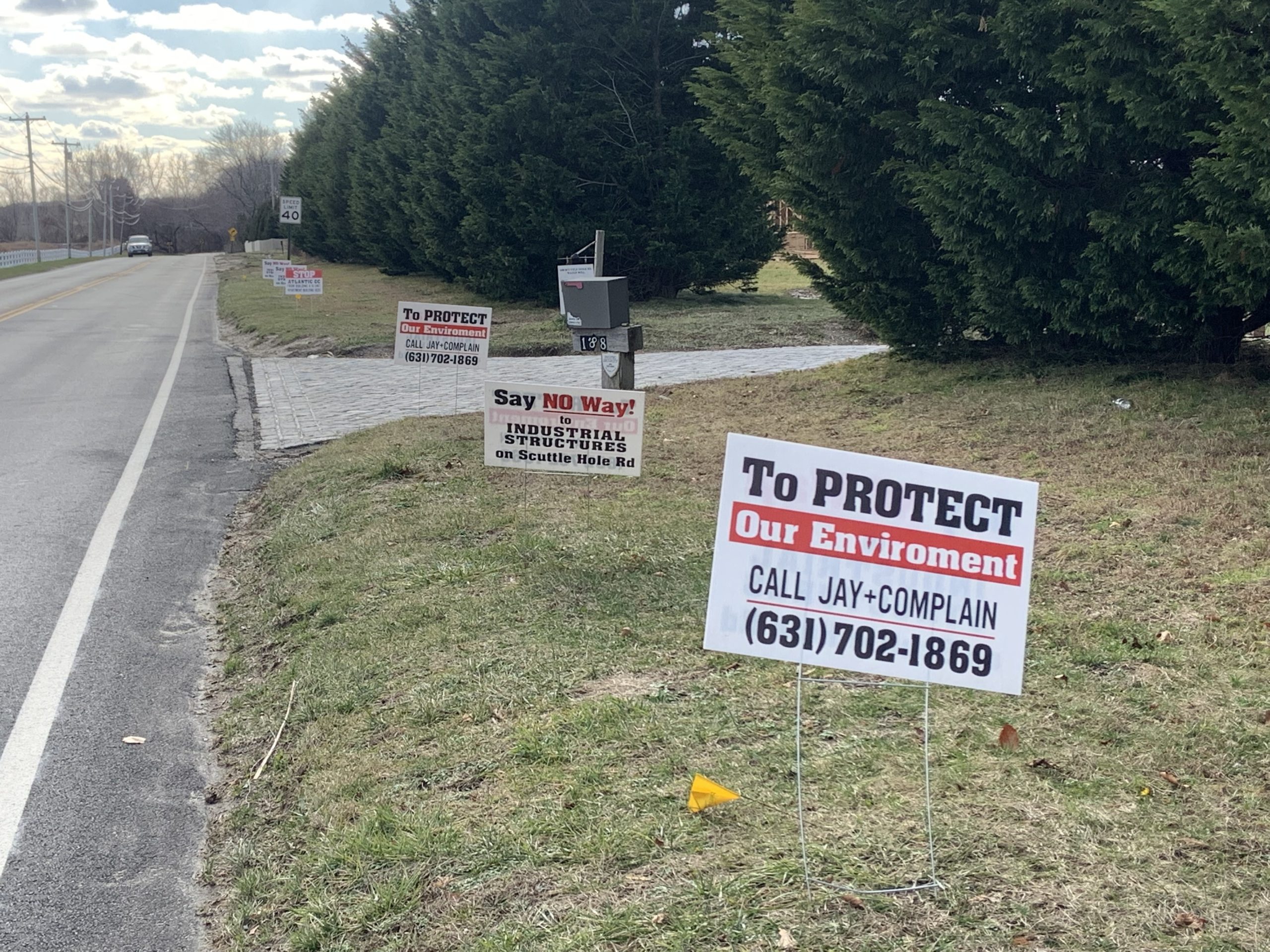 Signs on Scuttle Hole Road in Bridgehampton voice displeasure with the Southampton Town Planning Board's recent decision to approve the Atlantic Golf Club's application for a 16-bedroom worker housing building near Short's Pond. STEPHEN J. KOTZ