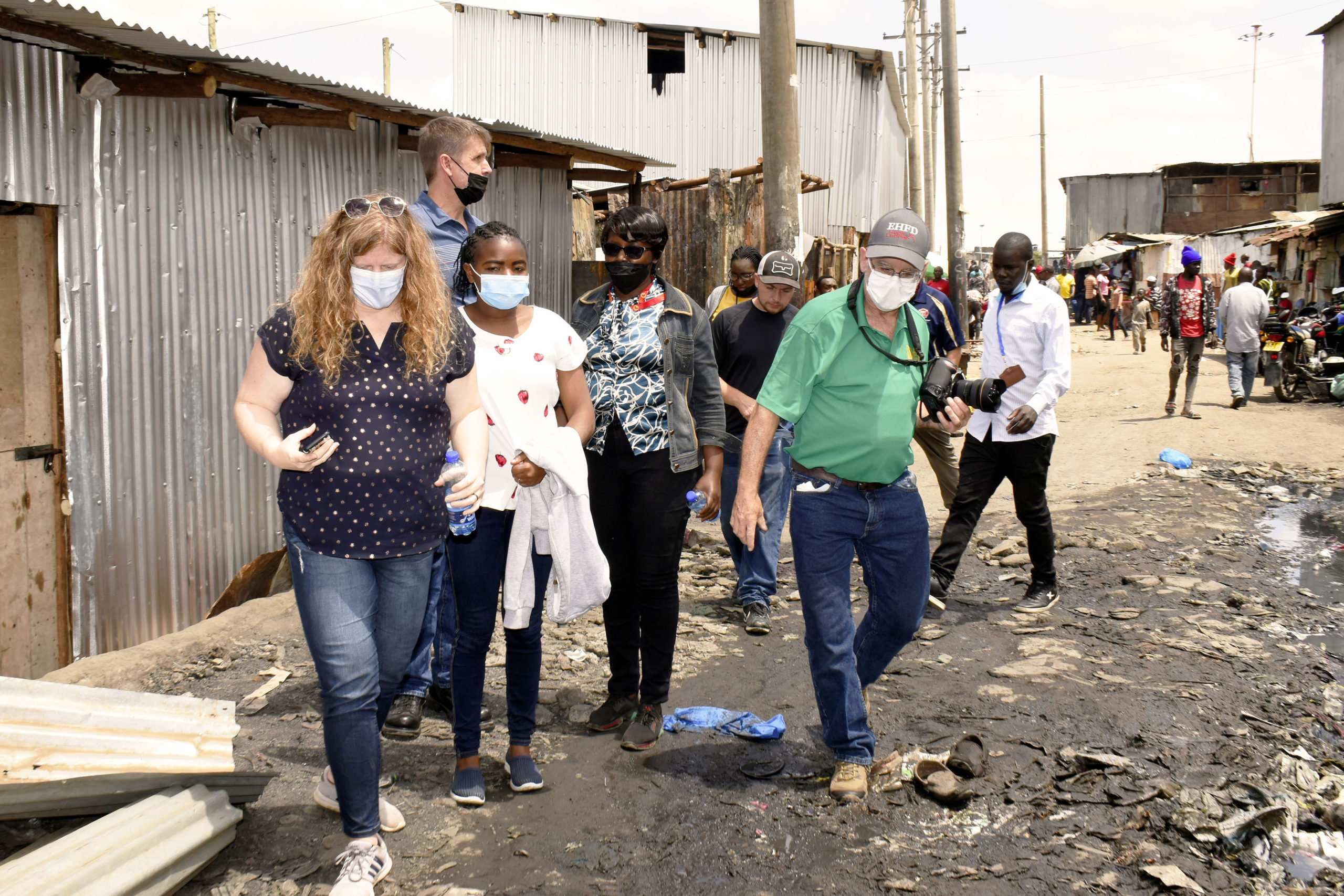 Michael Heller, right, walks with a group through the Mathare Valley slum, which is part of the larger Mathare slum, in Nairobi, Kenya.
