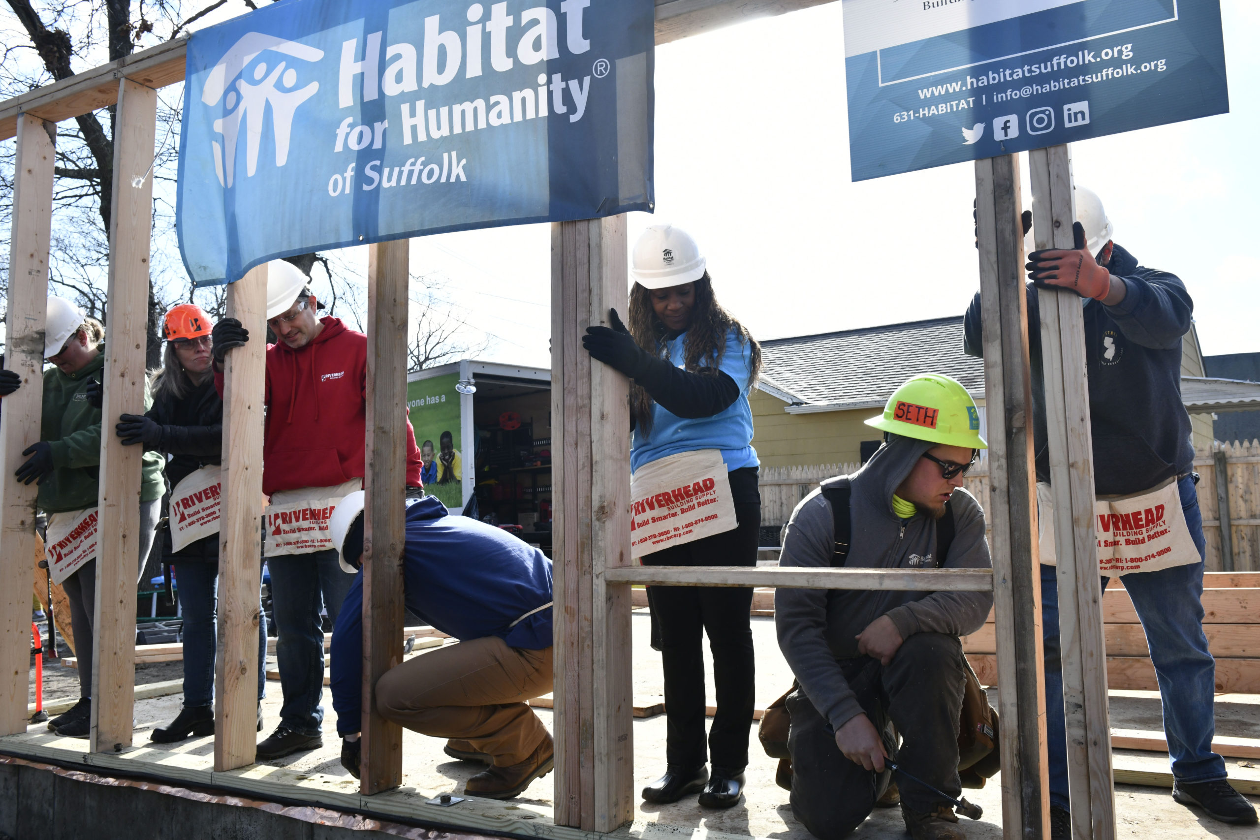 Homeowner Sahlise Cherry  raises a wall of her house with Habitat for Humanity volunteers.  DANA SHAW