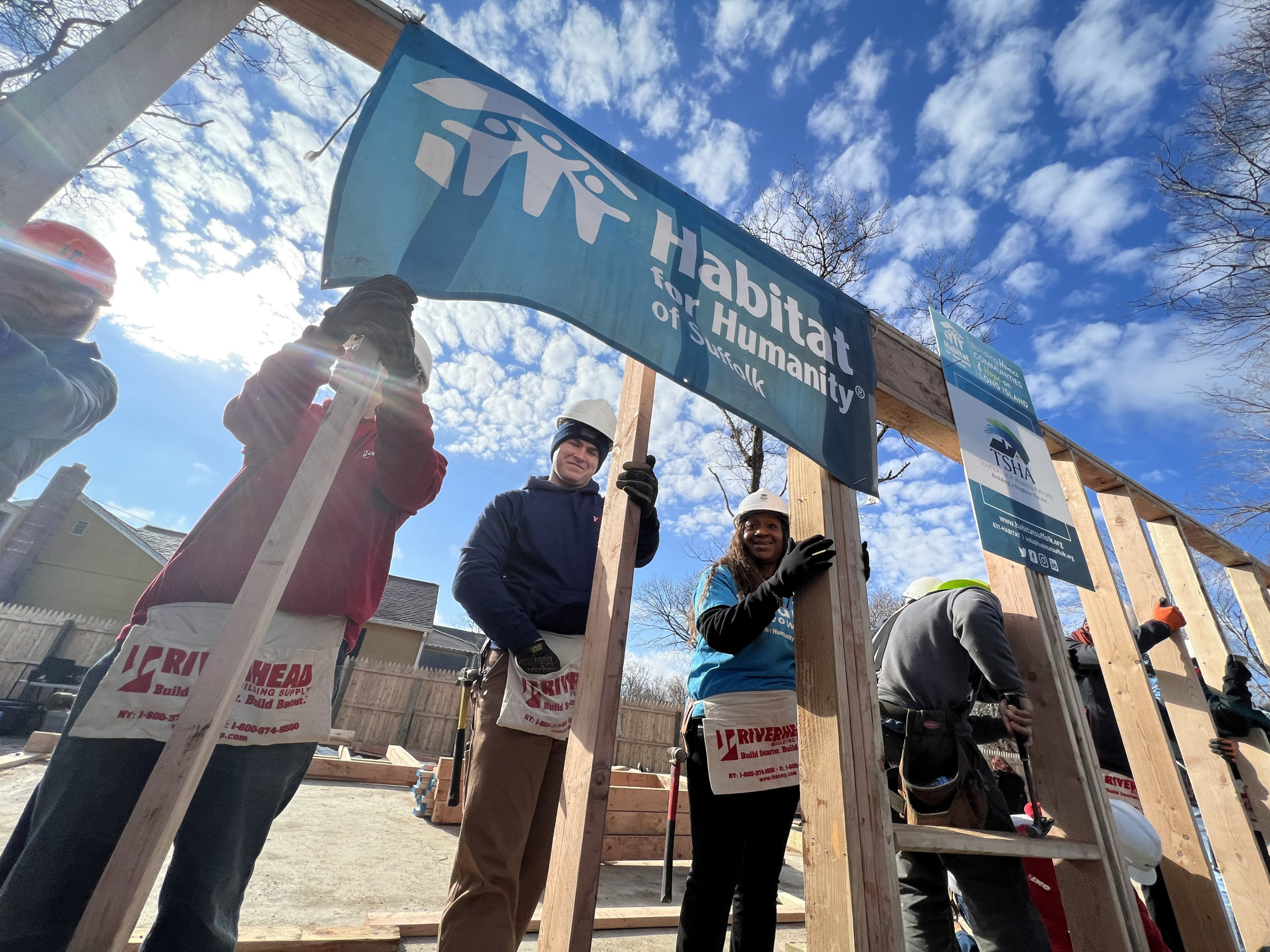 Homeowner Sahlise Cherry  raises a wall of her house with Habitat for Humanity volunteers.  DANA SHAW