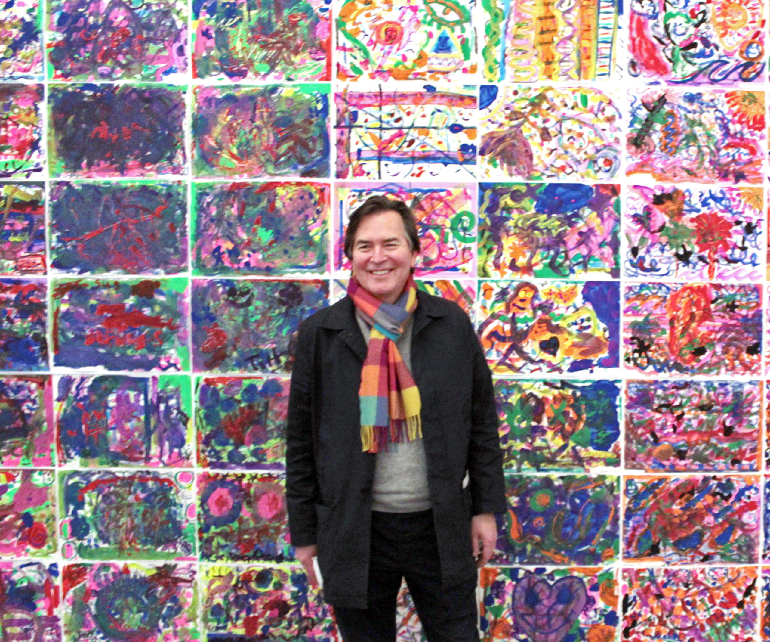 Artist-in-residence Eric Dever in front of the collaborative mural created by 250 students on site at the Parrish. TOM KOCHIE