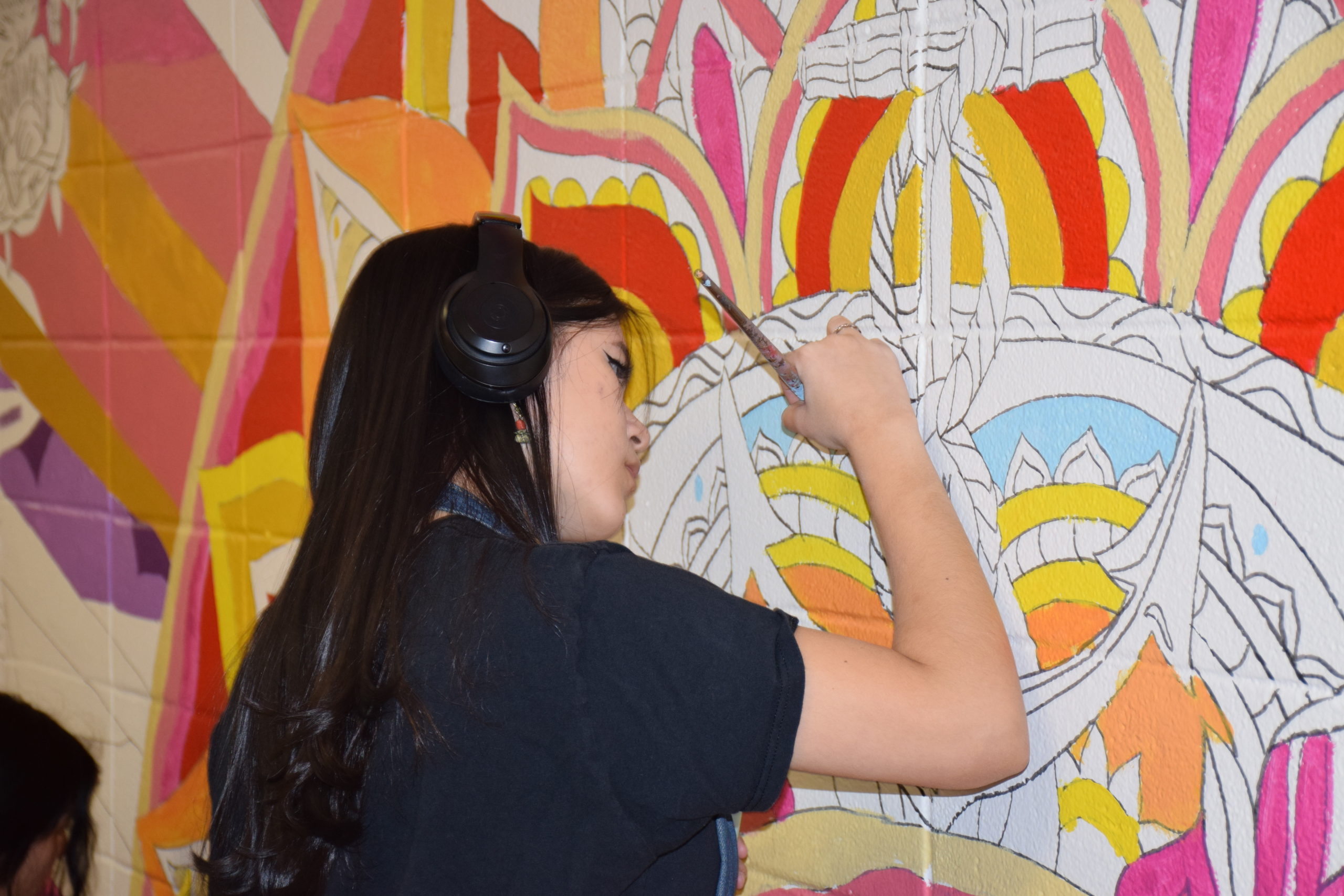 Hampton Bays High School students worked with professional muralist Joe Pimentel to design and paint a new mural in their school’s hallway.