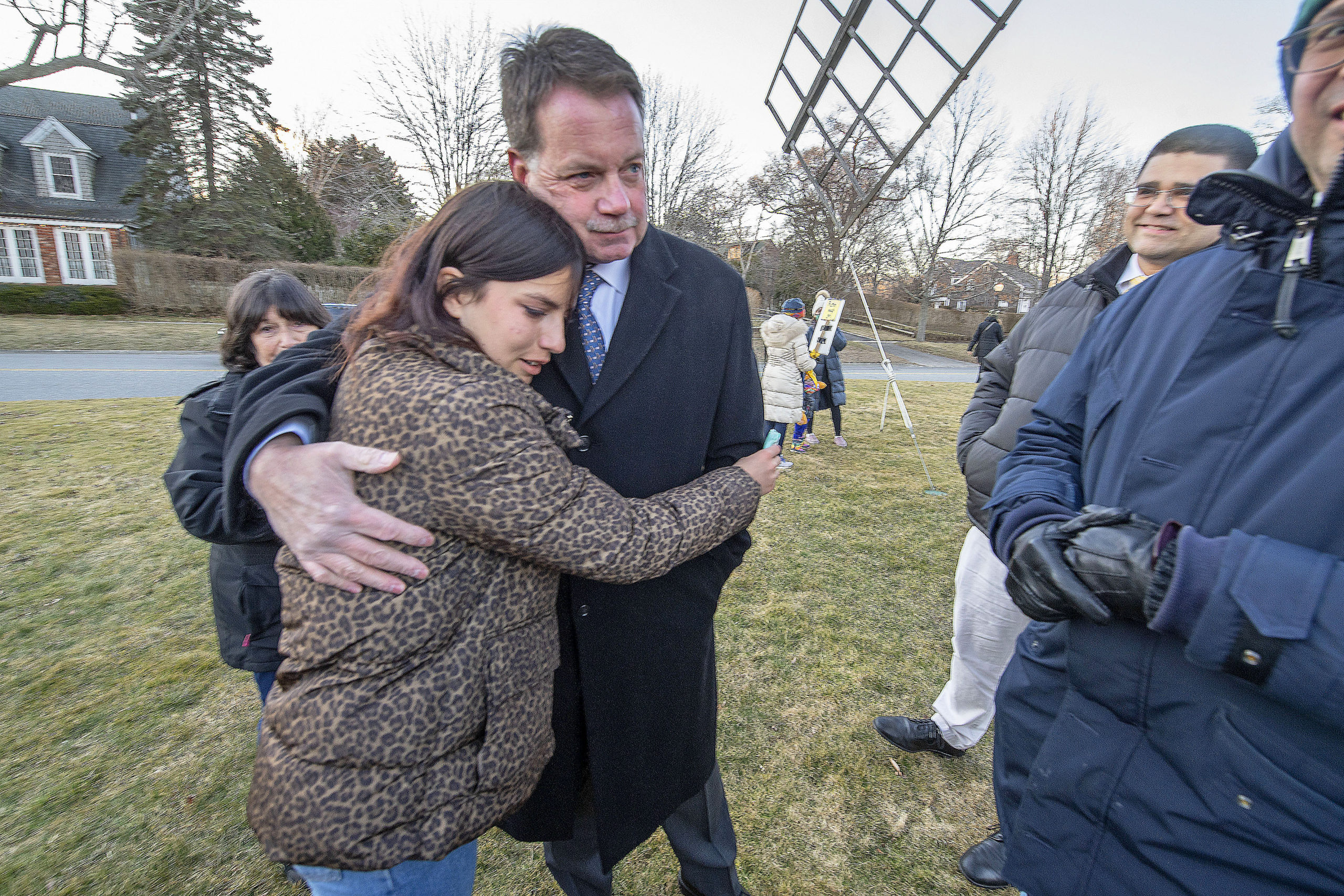 Vira Palamarchuk, whose father is fighting on the front lines in Ukraine, is comforted by East Hampton Village Mayor Jerry Larsen during a rally last Thursday on the Hook Mill Village Green in East Hampton. MICHAEL HELLER