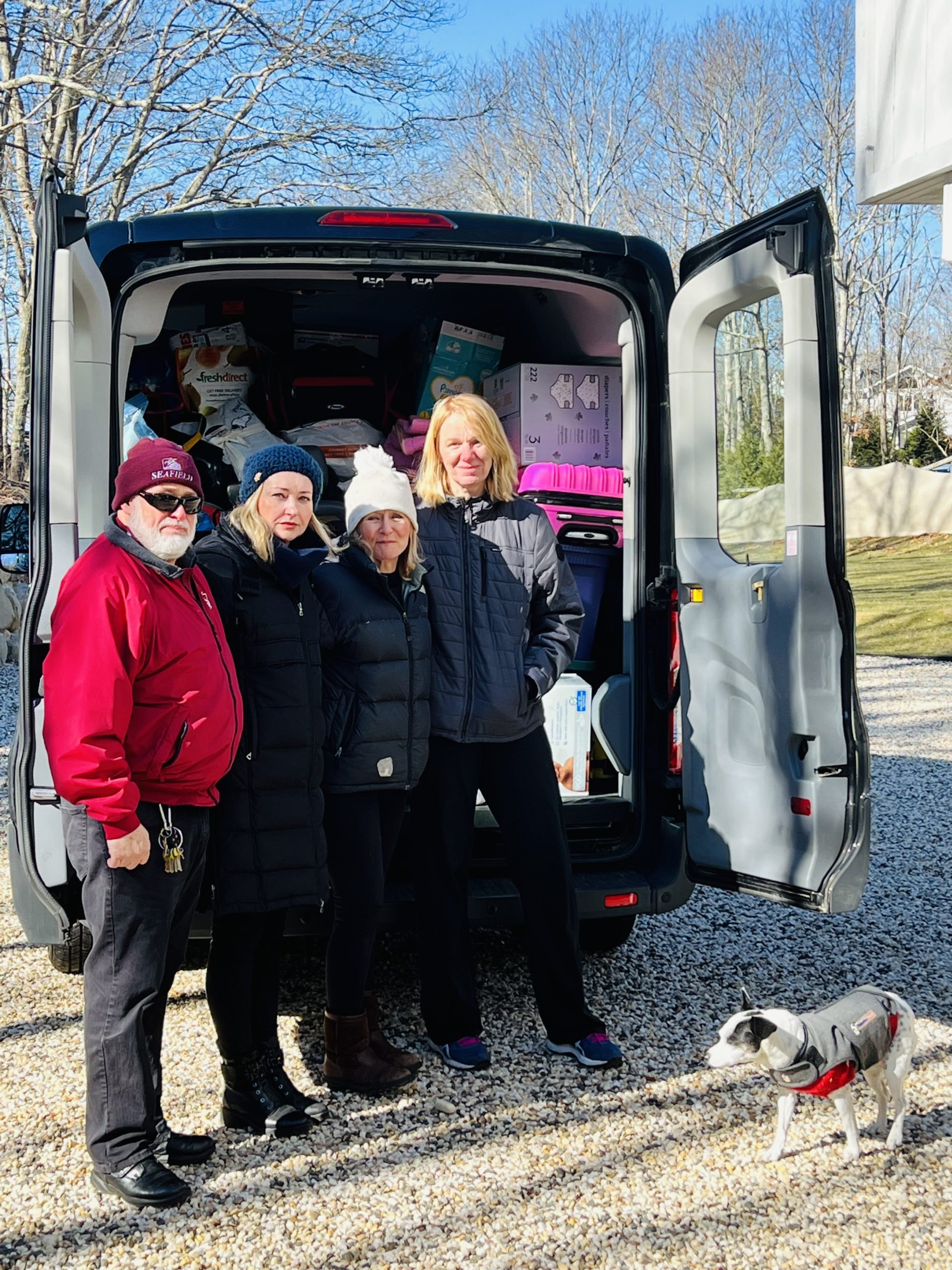Natalie Massa, center left, with a group of volunteers who helped collect Ukraine-bound donations that completely filled a van outside her home in Water Mill.