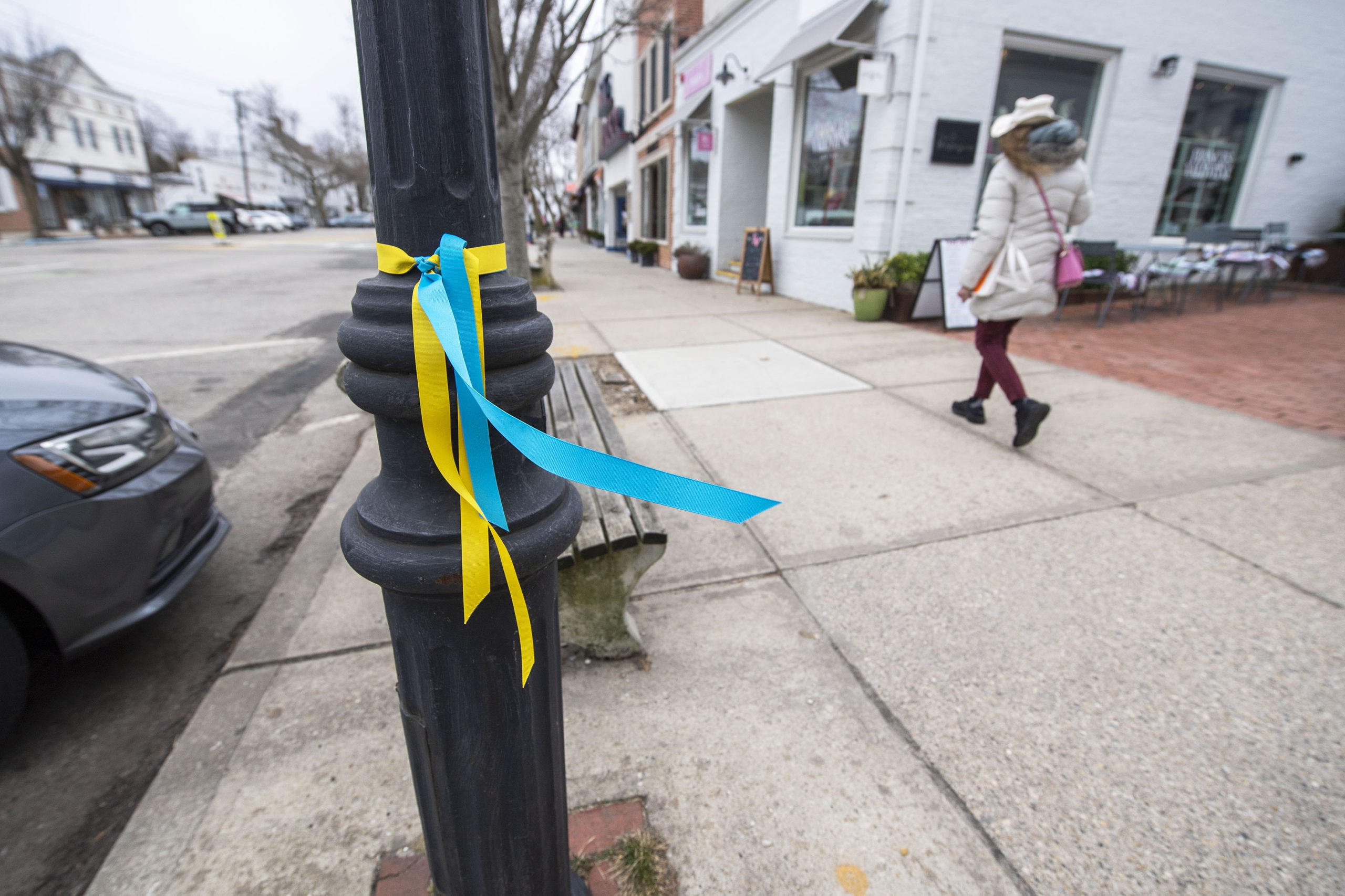 Blue and yellow ribbons were tied around all the street lampposts on Main Street in Sag Harbor in support of Ukraine, as seen on Monday.  MICHAEL HELLER