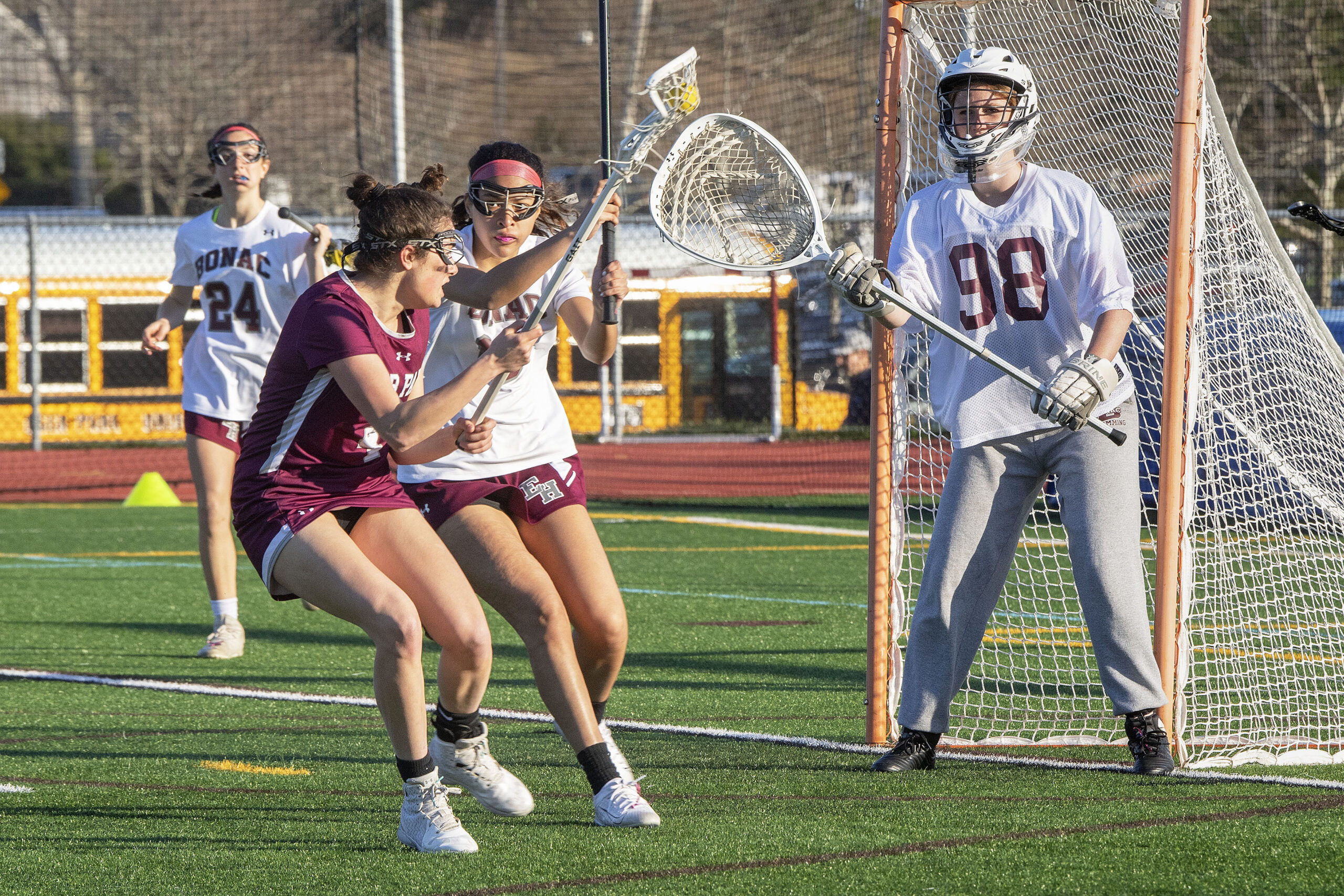 East Hampton senior Melanie Lugue defends against a Deer Park player with goalie Ruby Tyrrell backs her up.  Tyrrell got the start in goal after usual starting goalie Laura Calderon suffered a concussion in a game the day prior.   MICHAEL HELLER