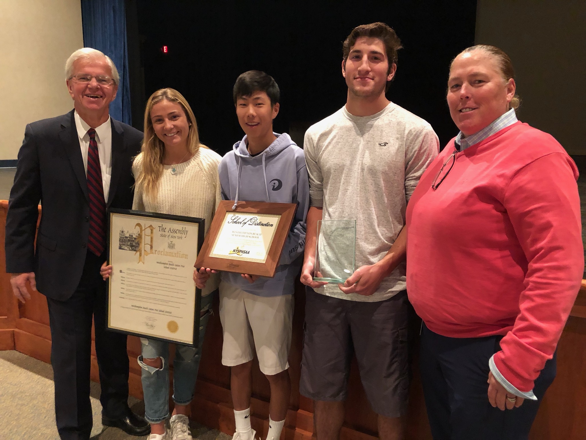 From left, New York State Assemblyman Fred W. Thiele Jr., Isabelle Smith, Mackenzie Kim, Jesse AlfanoStJohn and Westhampton Beach Athletic Director Kathy Masterson. Thiele  issued a proclamation recognizing the school for becoming a New York State Public High School Athletic Association “School of Distinction” in 2019.    CAILIN RILEY