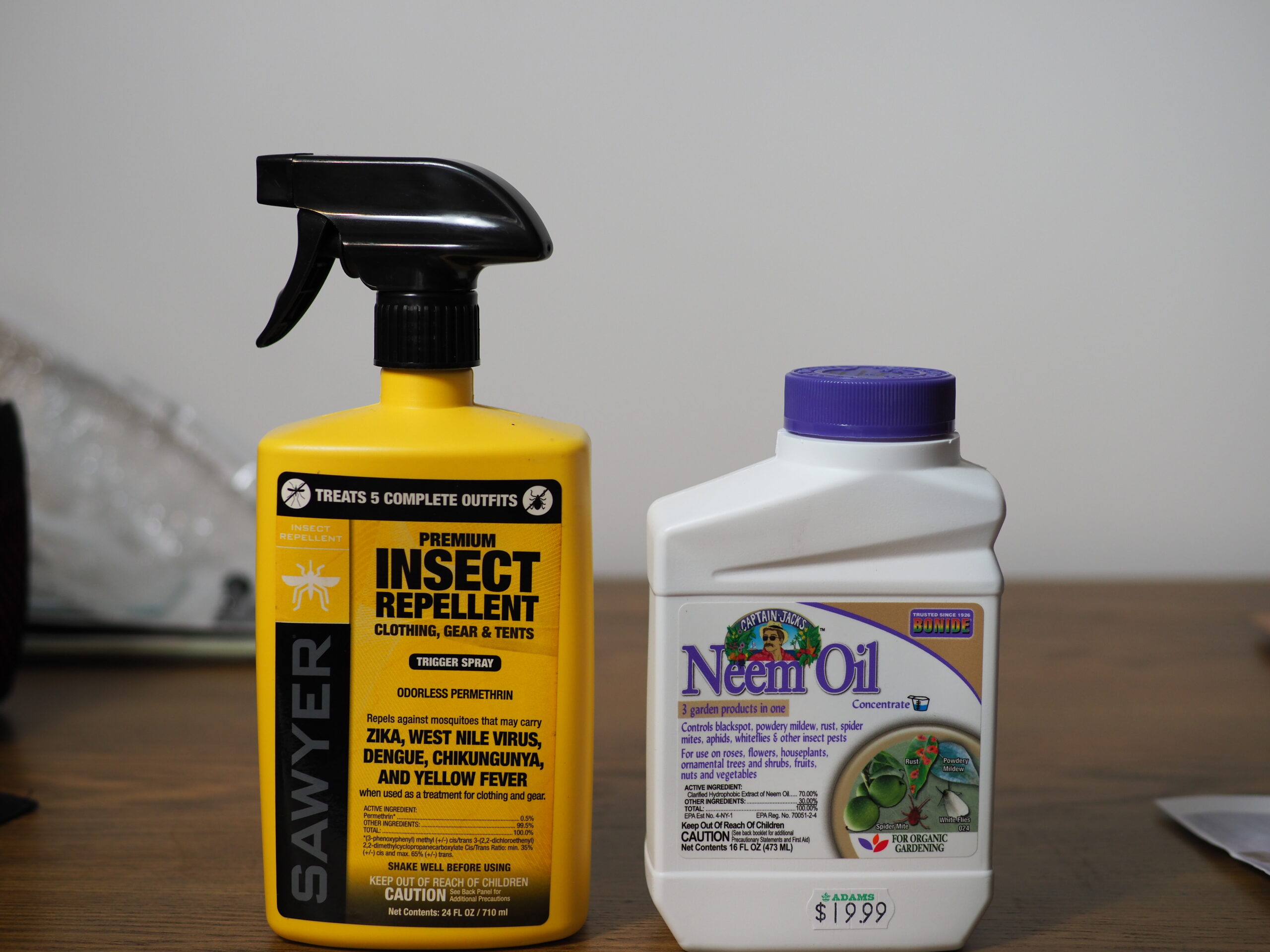 Sawyer permethrin on the left is one of the best tick repellents. Sprayed on clothing, it remains effective for several weeks even after washing clothes. Never apply it directly to your skin. On the right is one brand of neem oil. While an interesting organic insecticide, its important to learn how to use it and how it works.