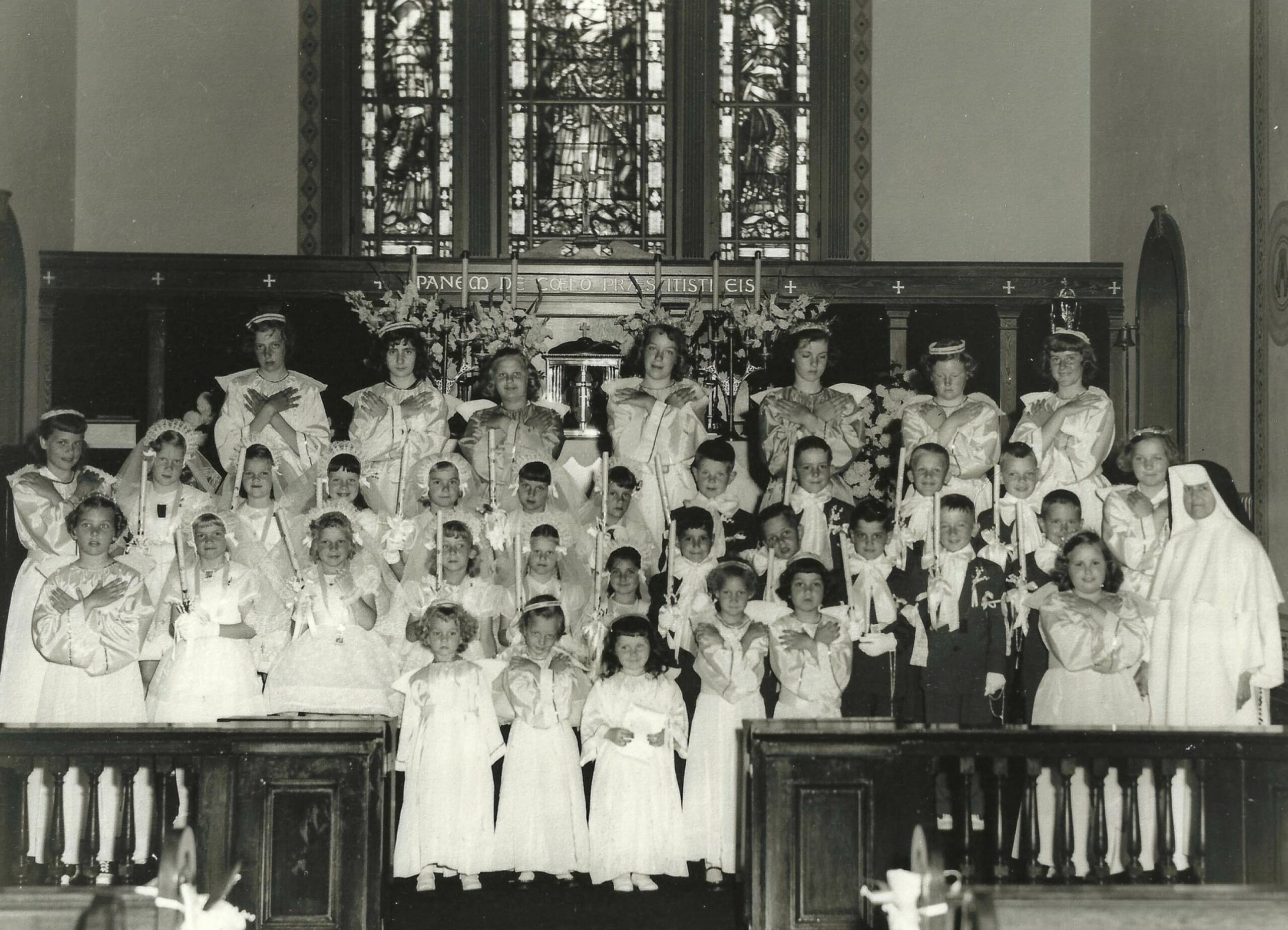 A First Communion class gather in the church sanctuary. COURTESY QUEEN OF THE MOST HOLY ROSARY CATHOLIC CHURCH