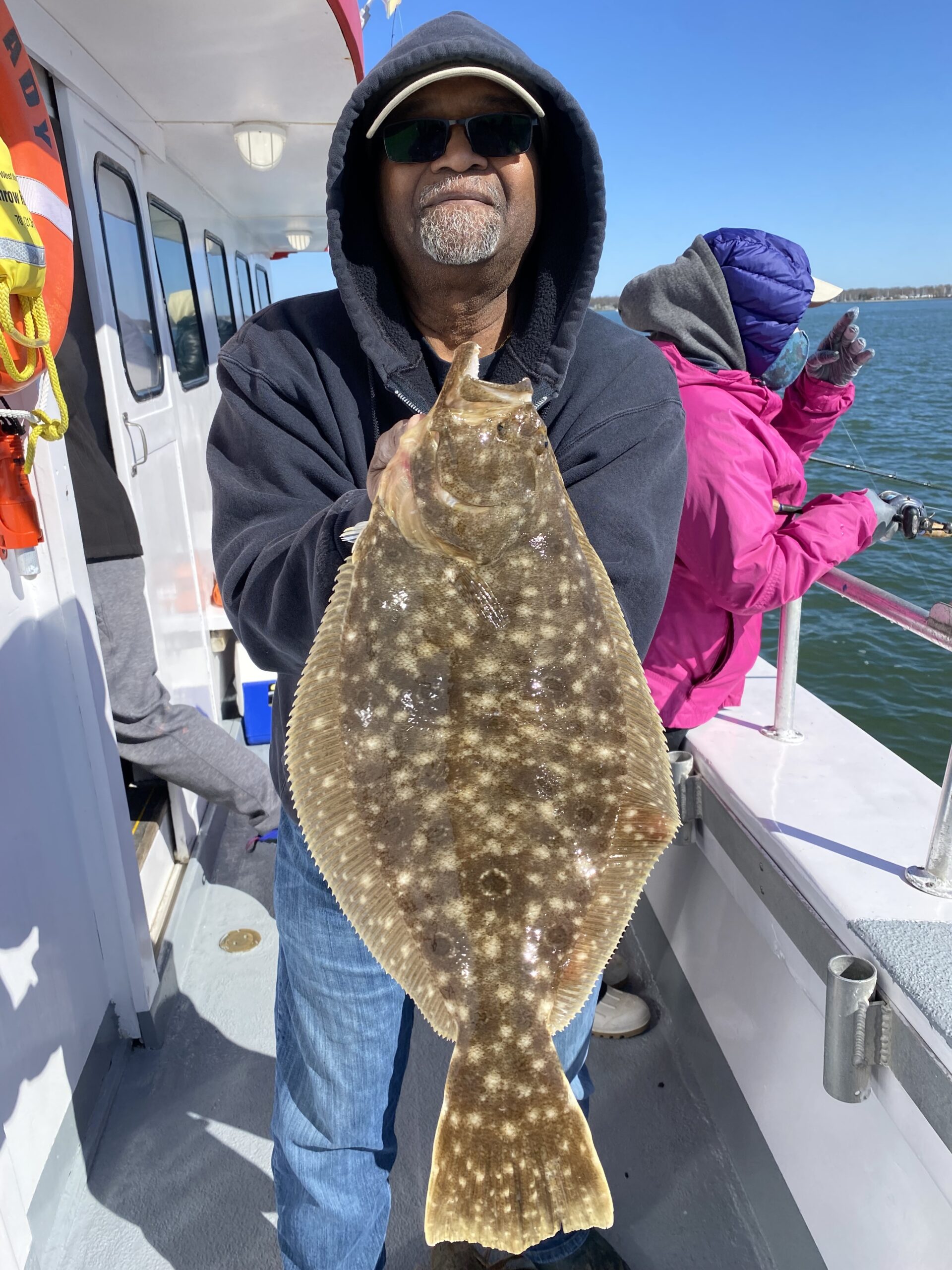 Ron King shows off one of the first East End fluke to come to the net on Sunday morning while fishing in Peconic Bay aboard the Hampton Lady.