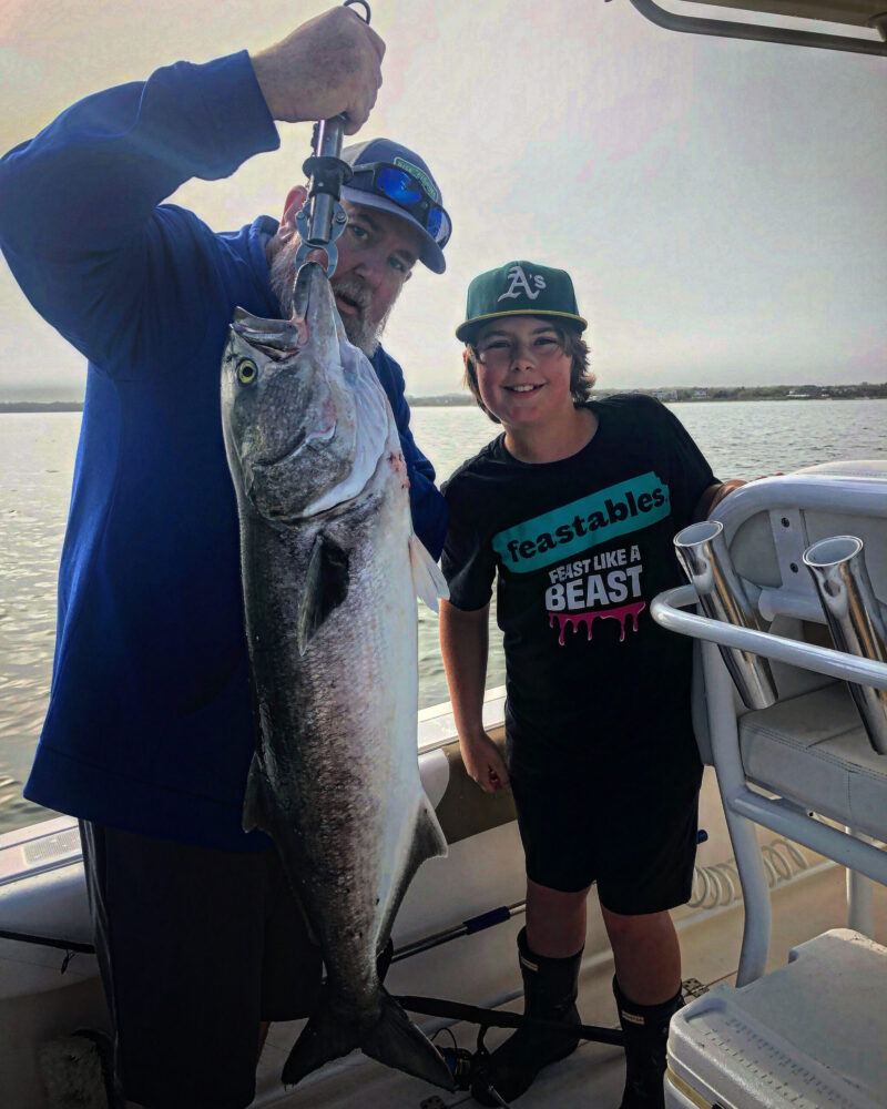 Mike and Michael Dean and one of the gorilla bluefish that have been roaming the bays and ocean shorelines recently.