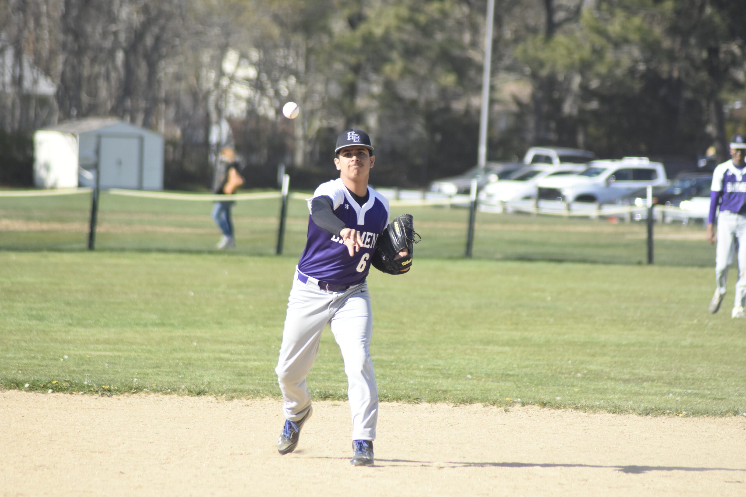 Hampton Bays second baseman Eustorgio Urbano throws to first base for an our after fielding a ground ball.     DREW BUDD