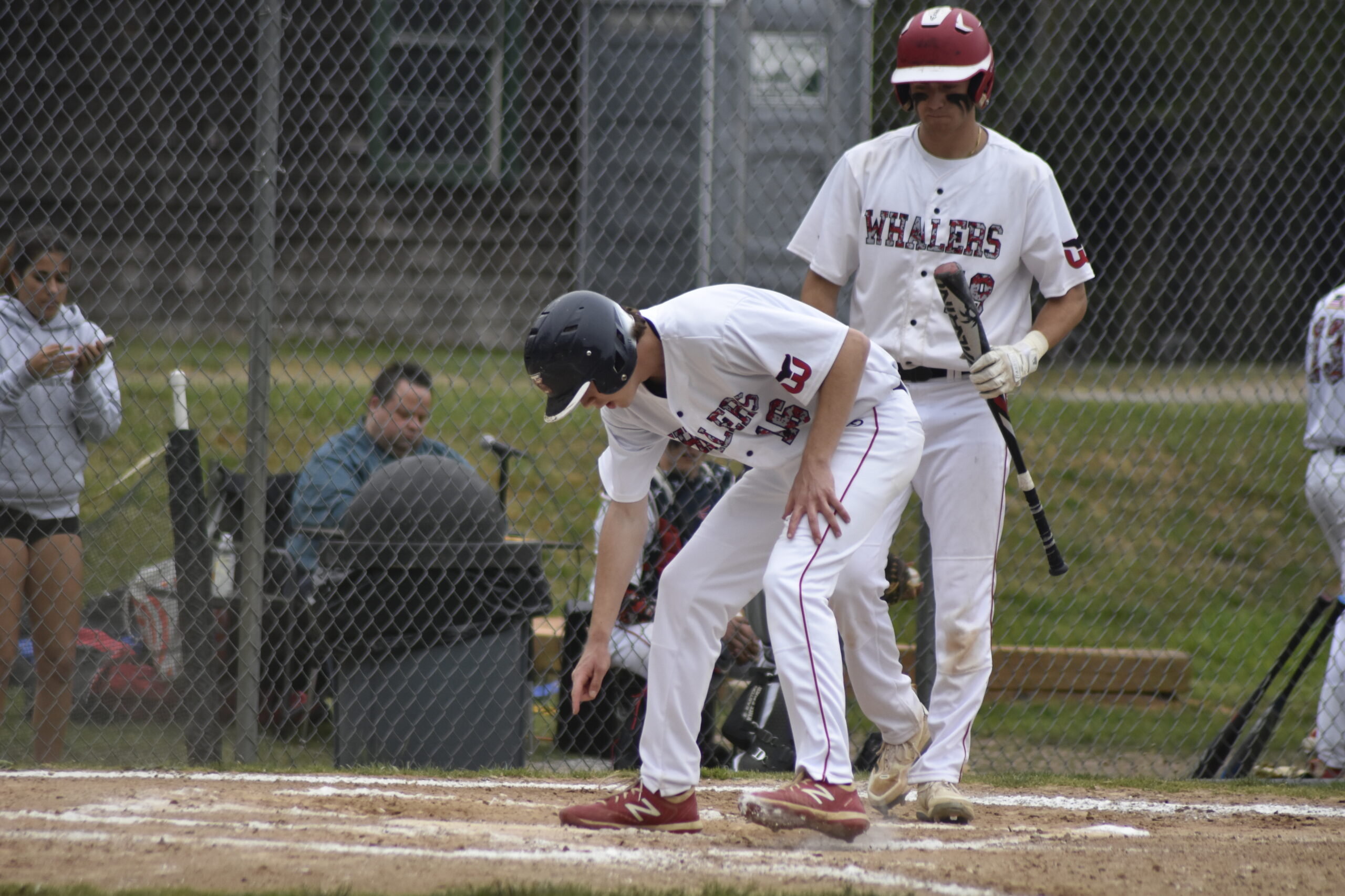 Dan Labrozzi reaches down to touch home plate for the game's first run on Friday.   DREW BUDD