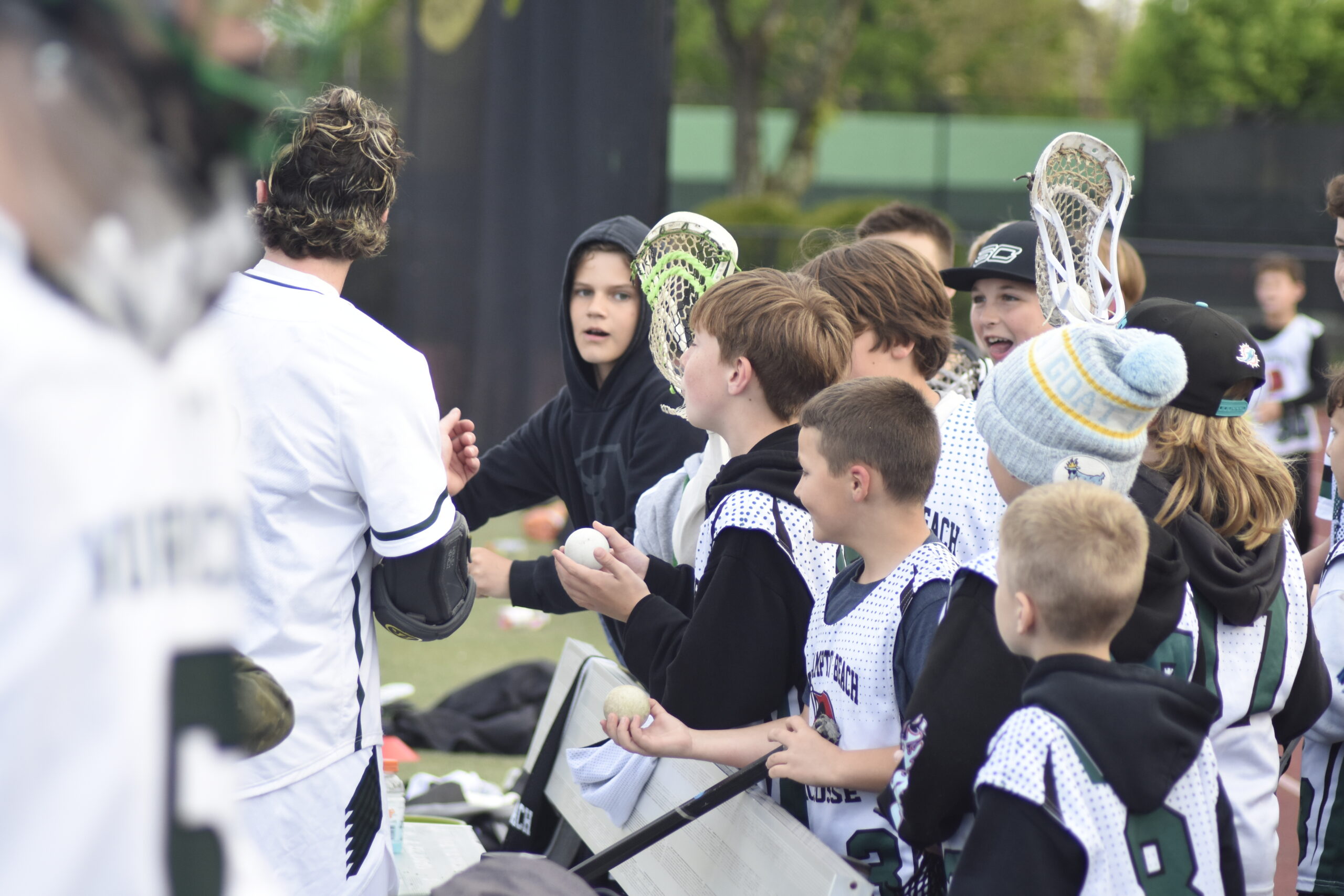 A Westhampton Beach player gives a youth lacrosse player a game ball after the game.   DREW BUDD