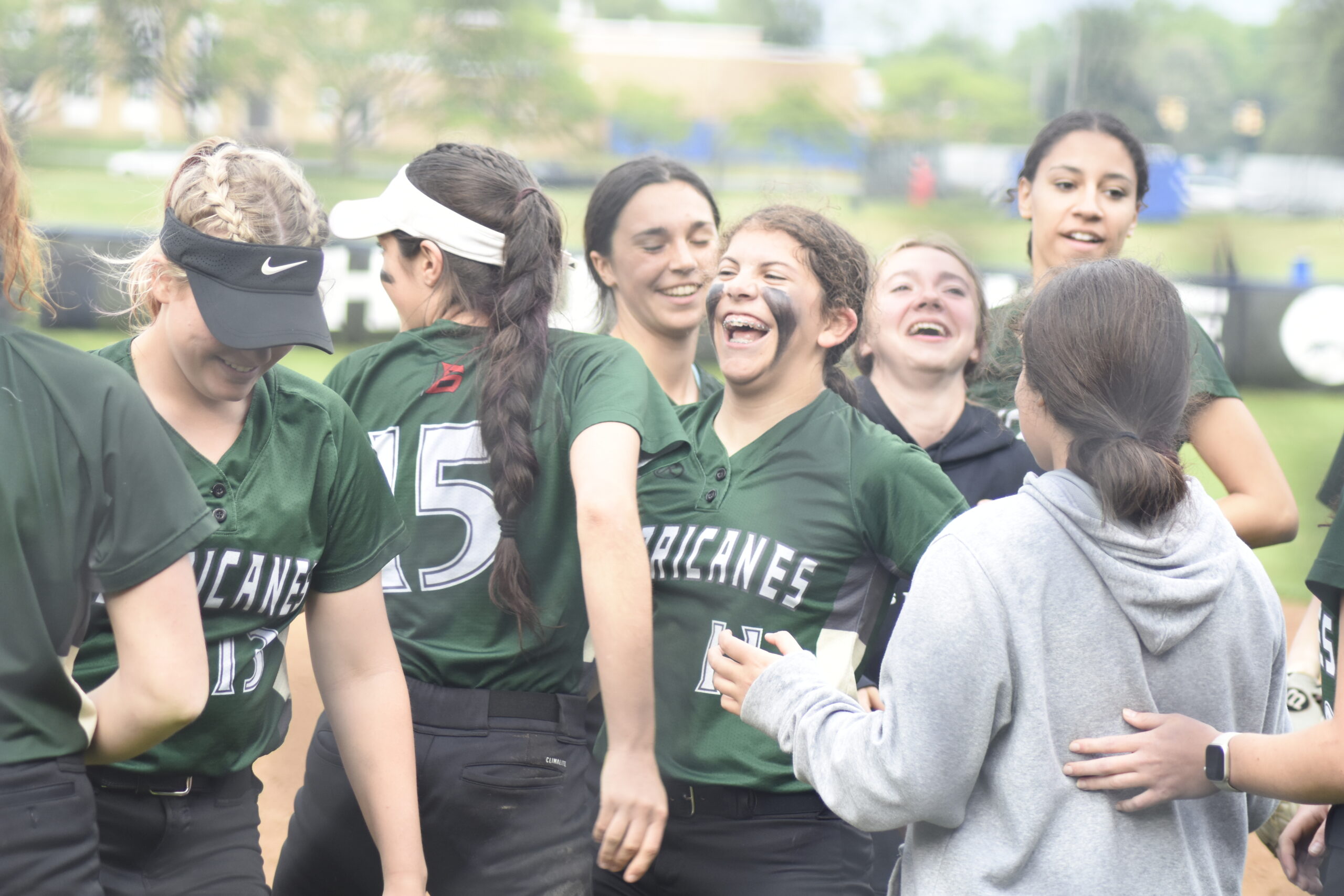 Addison Celi is congratulated by her teammates after she delivered a strong performance in the pitching circle on Friday.    DREW BUDD
