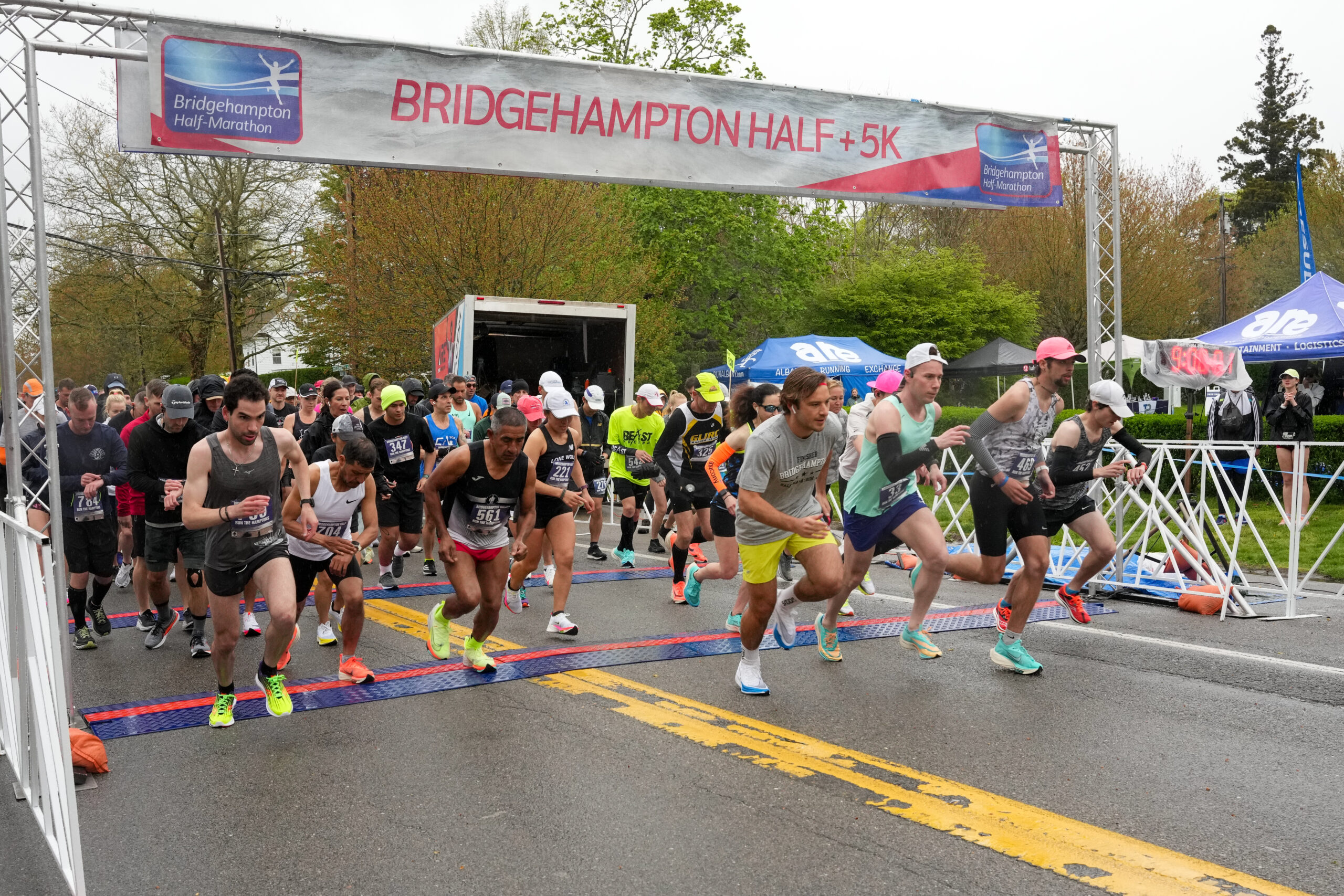 Runners start the seventh annual Bridgehampton Half-Marathon amid rainy and windy conditions on Saturday.  RON ESPOSITO