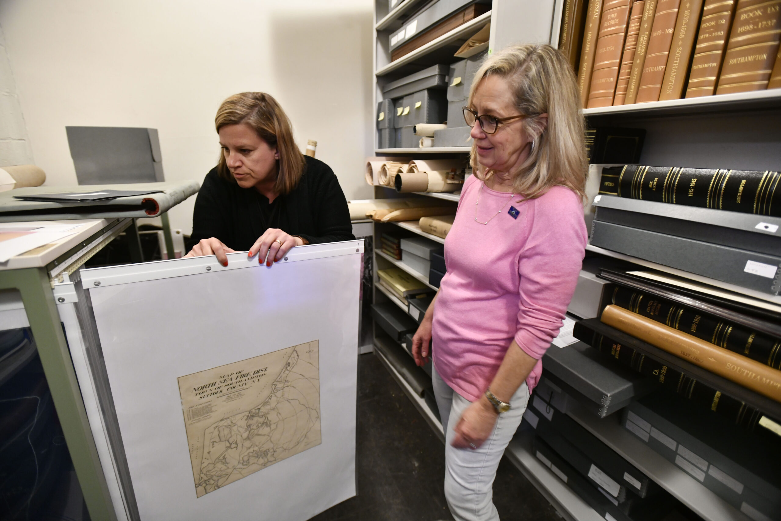 Julie Greene and Sundy Schermeyer with the maps that have protected and archived.  DANA SHAW