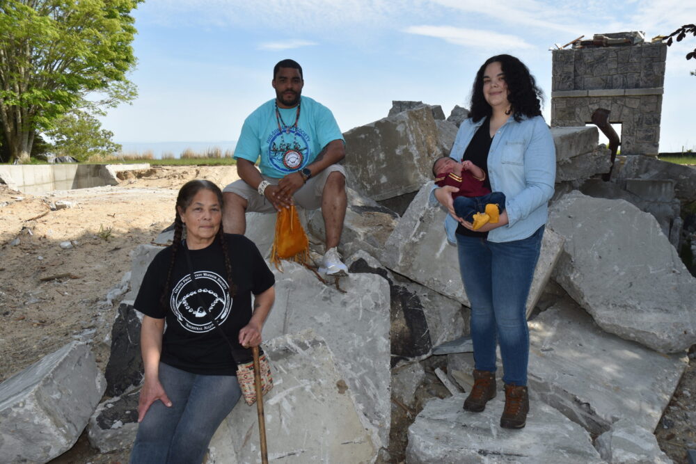 Members of the Shinnecock Graves Protection Warrior Society, from left, Becky Genia, Shane Weeks, and Tela Troge, holding her infant son, Benjamin Ballard, at the site of the Nappa home on Sugar Loaf Hill in Shinnecock Hills. STEPHEN J. KOTZ
