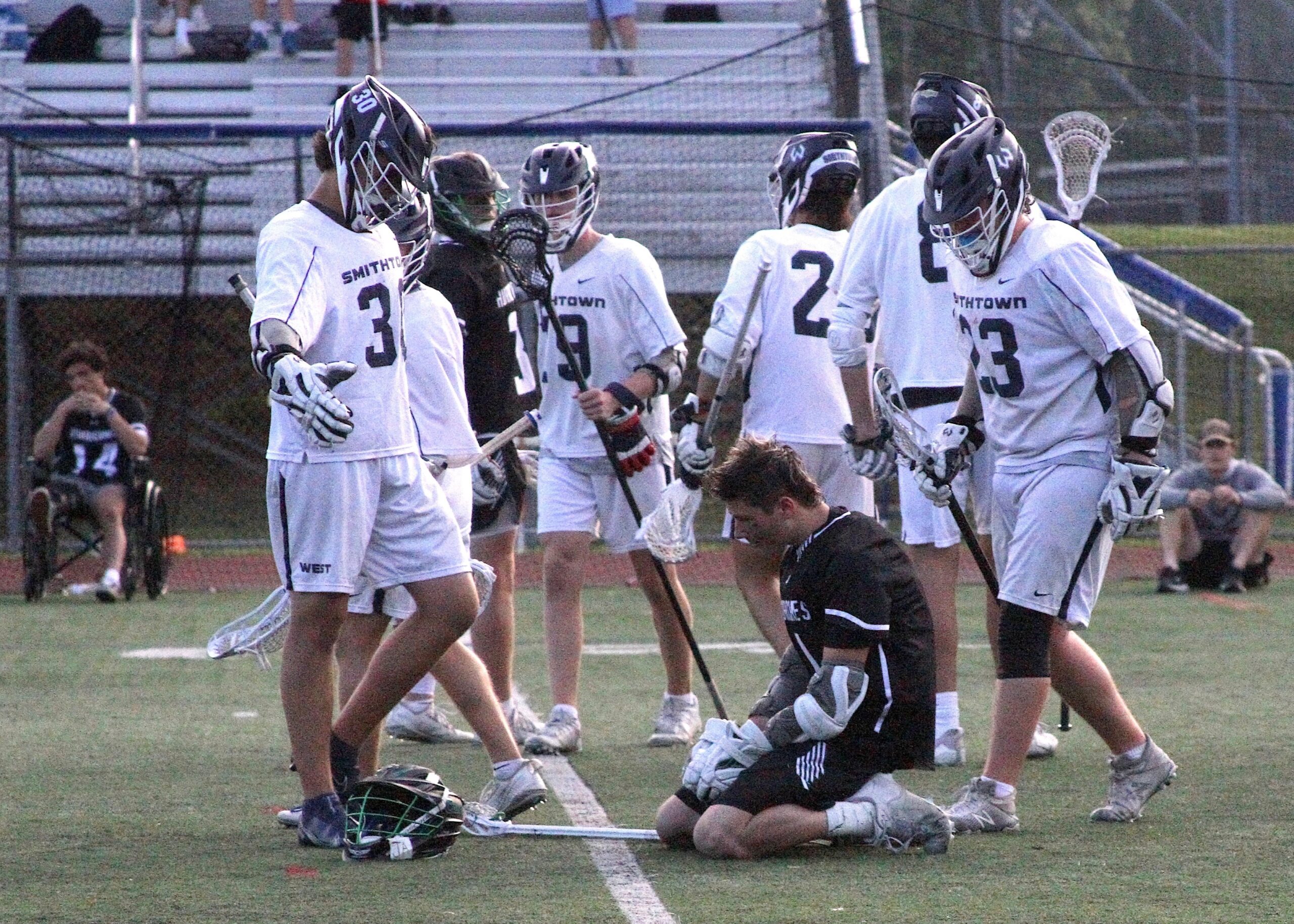 Senior attack Gavin Arcuri is helped up and congratulated by his opponents following his team's loss. DESIRÉE KEEGAN