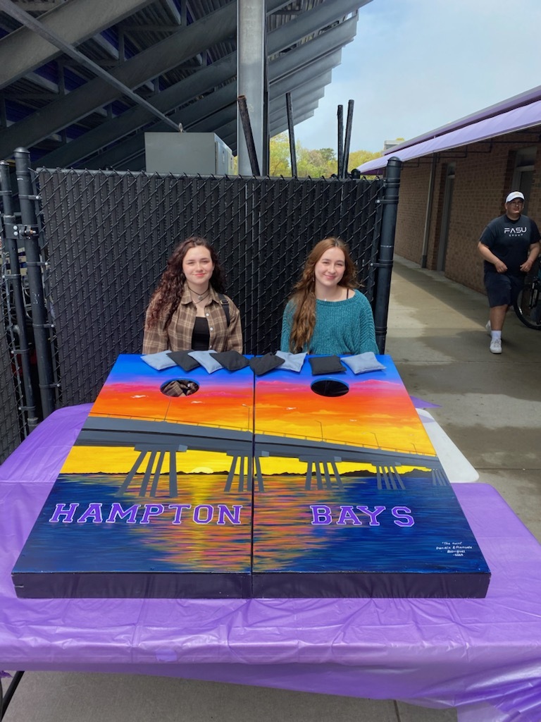 Hampton Bays seniors Daniela and Manuela Rodriguez painted cornhole boards that went to the winning team on Saturday.